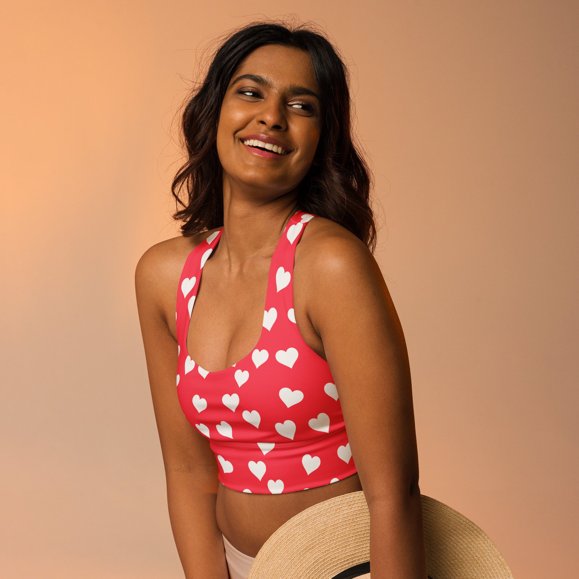 Women’s vibrant red heart patterned buttery soft recycled longline sports bra with high intensity support and quick dry features
