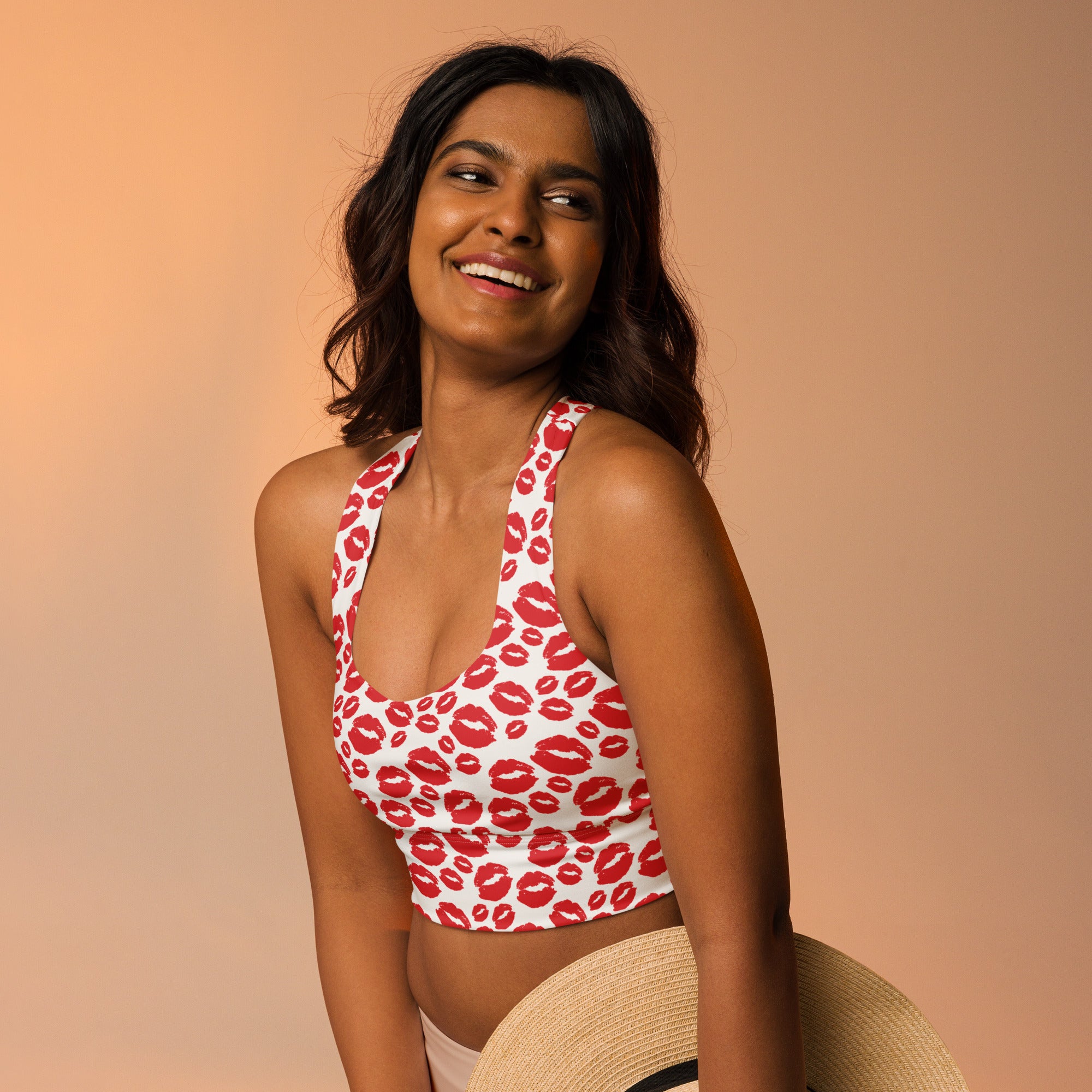White longline sports bra with red lipstick print made from buttery soft recycled fabric for high intensity support