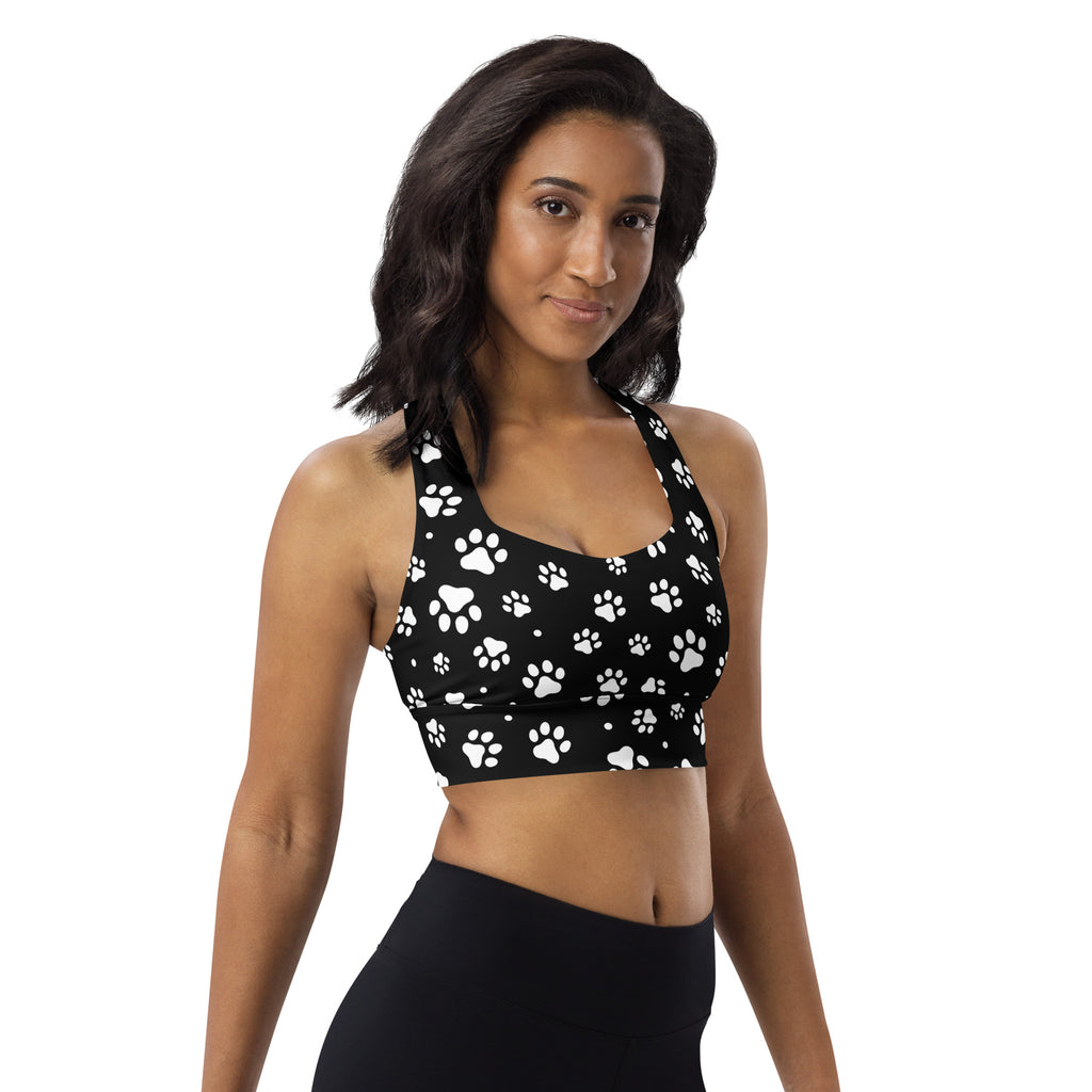 Black sports bra with white paw print pattern featuring buttery soft recycled fabric and high intensity support