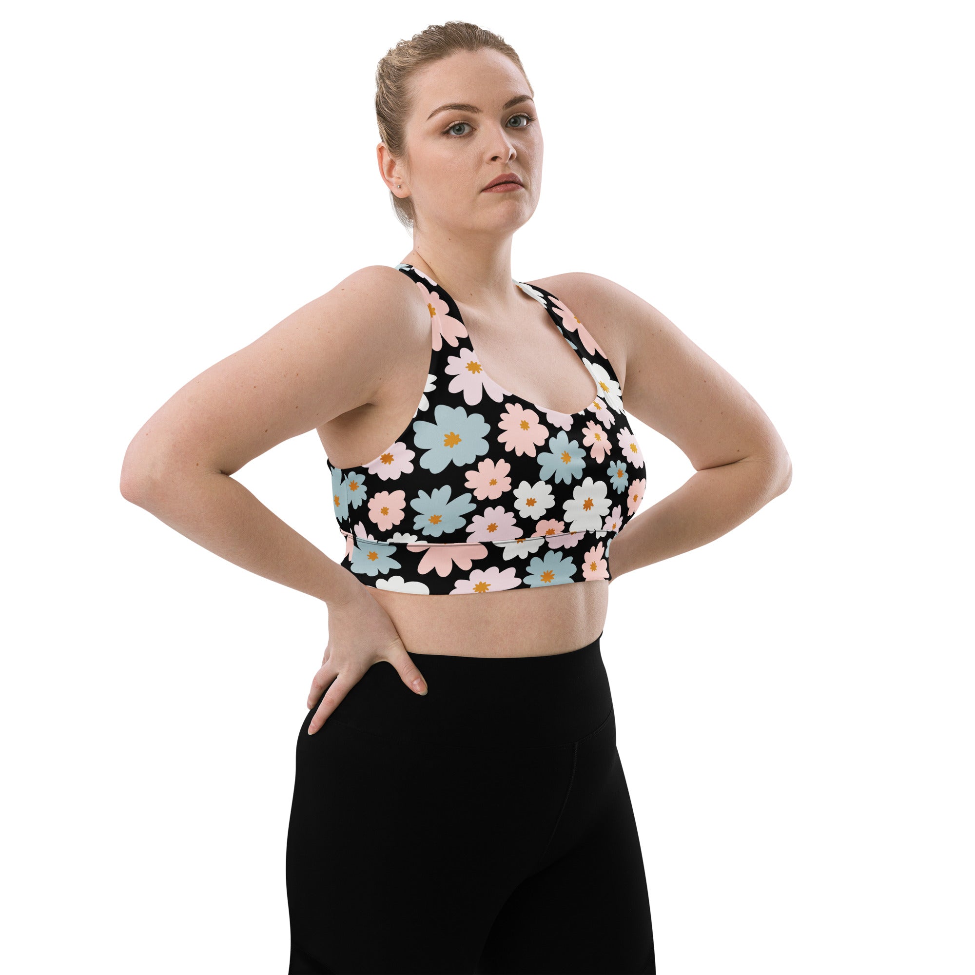 Black longline sports bra with vibrant pastel pink blue and white daisies, buttery soft recycled fabric, high support