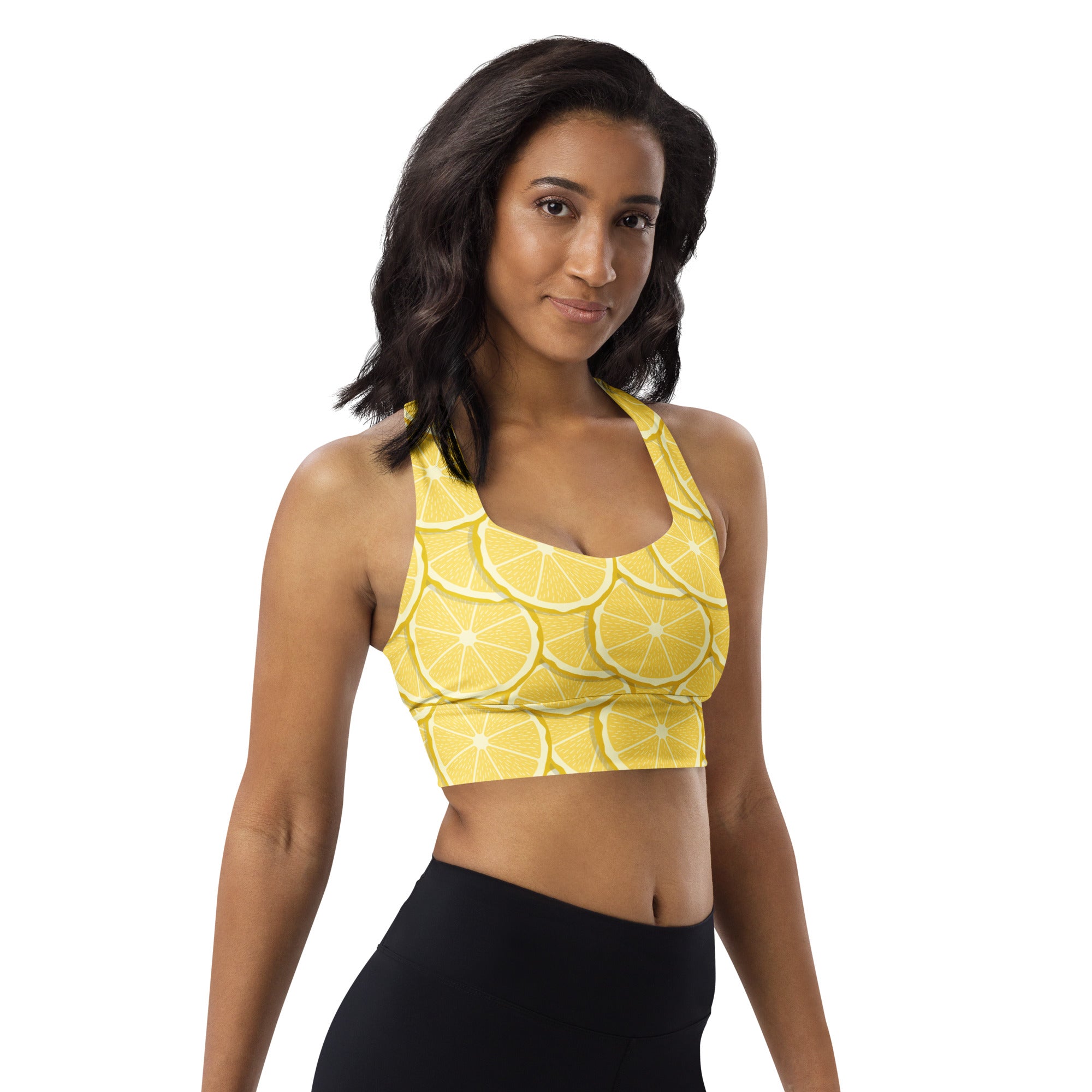 A vibrant yellow longline sports bra with sliced lemon print made from buttery soft recycled fabric for high intensity support