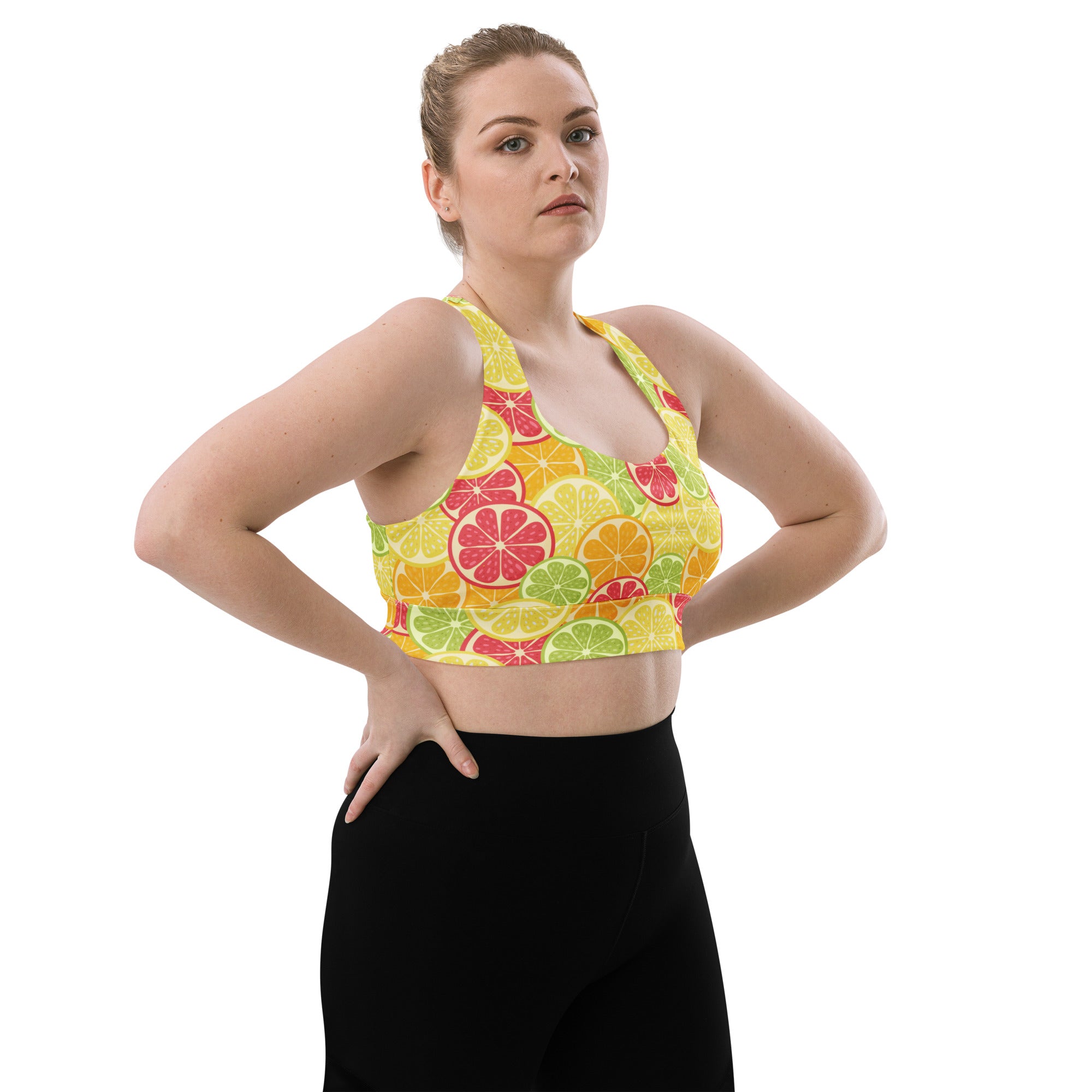 A vibrant yellow womens citrus slice buttery soft recycled longline sports bra with citrus fruit pattern