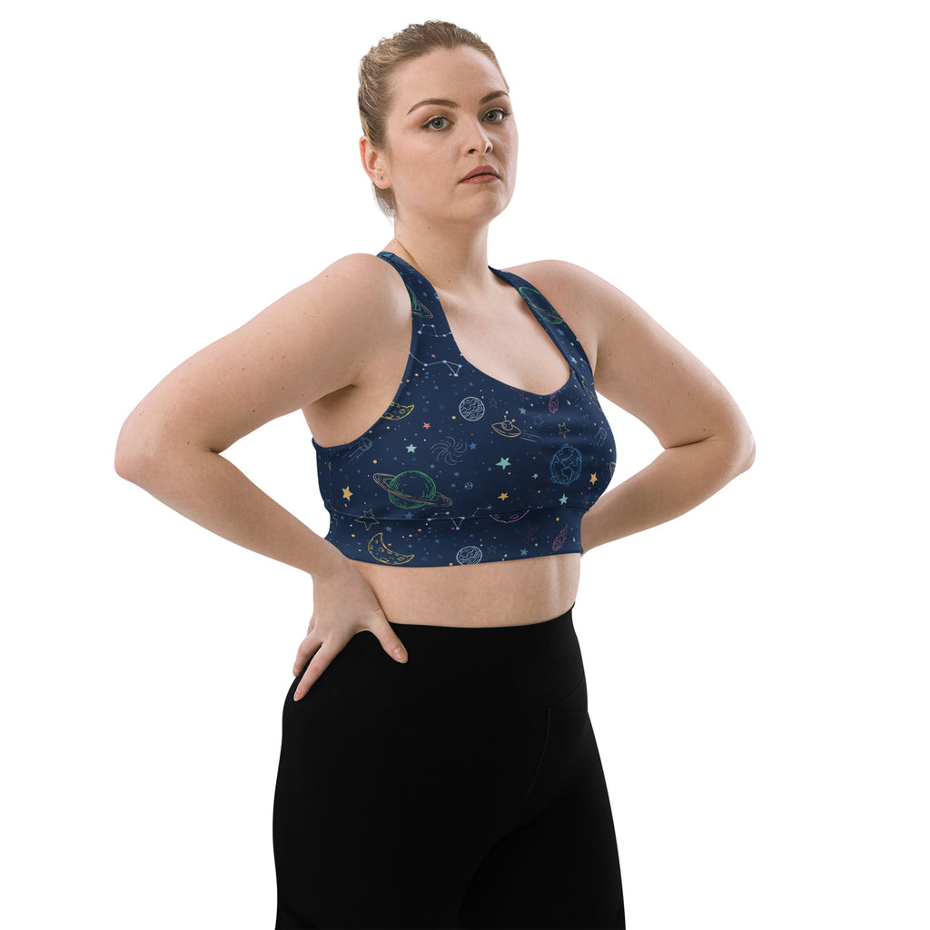 Dark blue space-themed longline sports bra with celestial gold and light green patterns, buttery soft recycled fabric