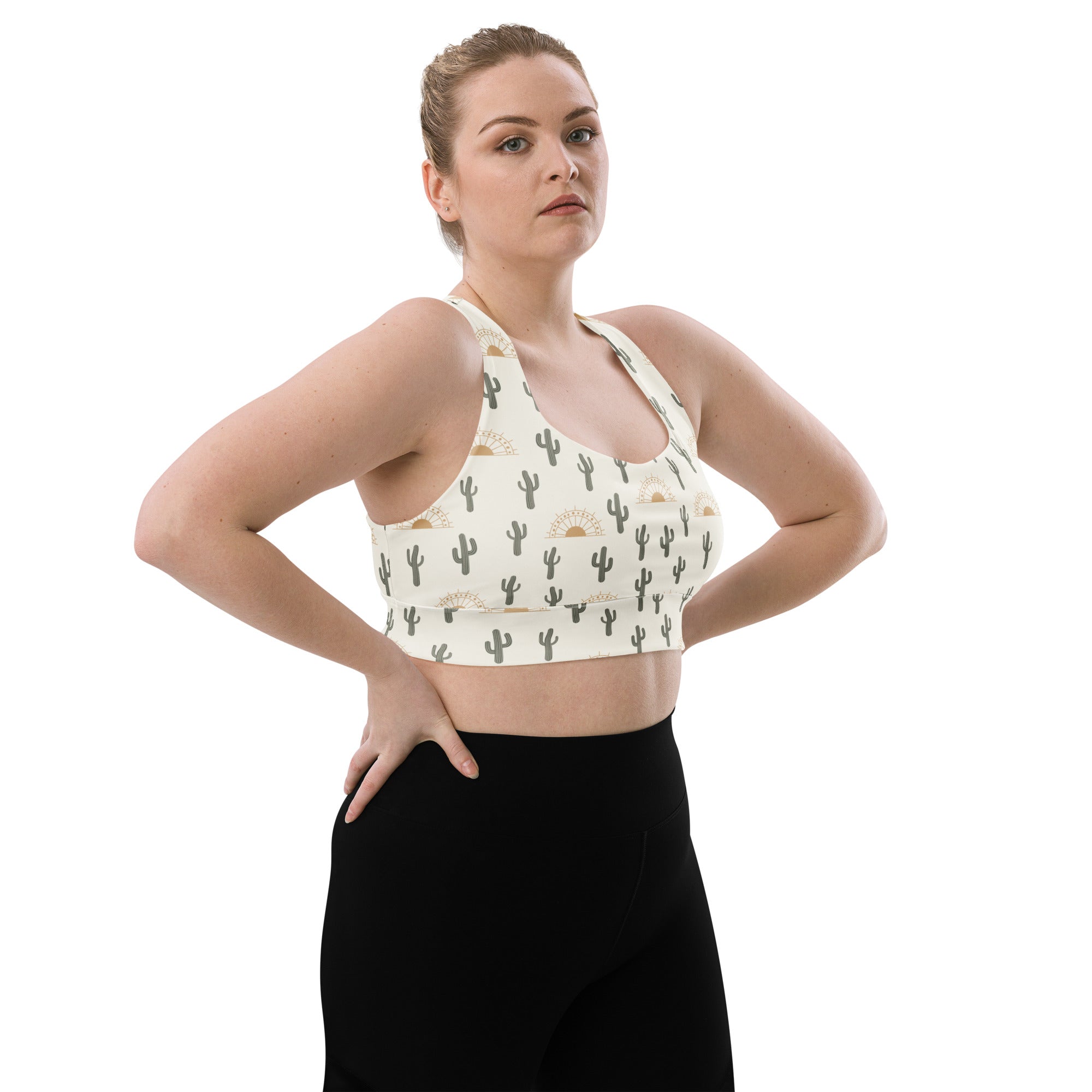 Cream-colored buttery soft recycled longline sports bra with black cactus and gold sun pattern for high intensity support