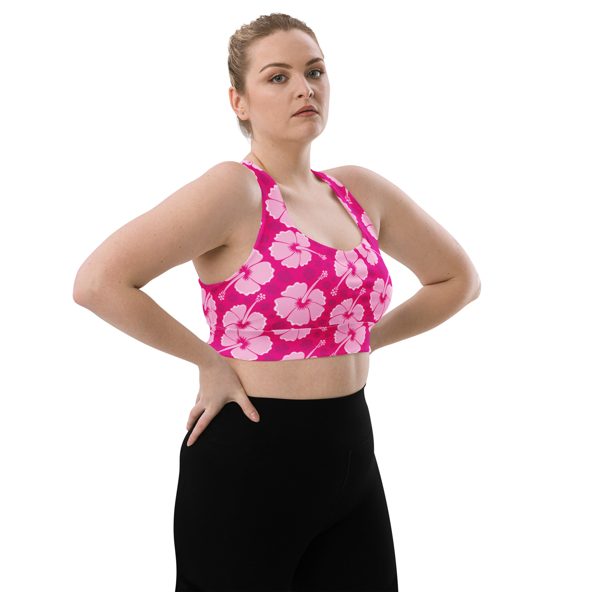 Women’s vibrant pink hibiscus sports bra with bold flower pattern buttery soft recycled fabric high intensity support