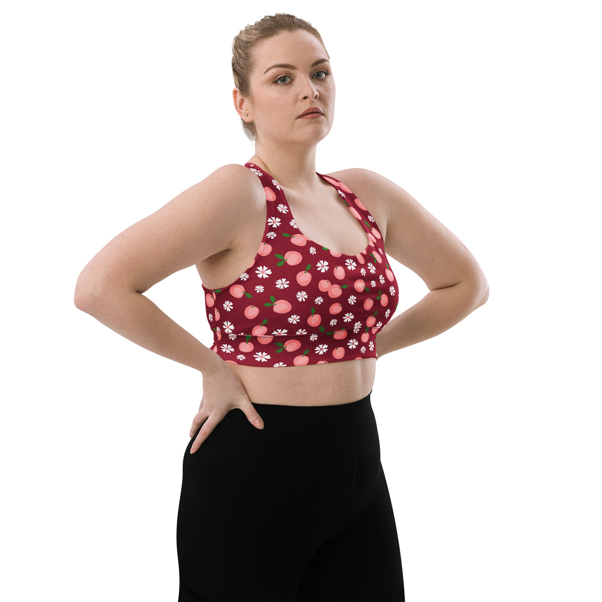 A maroon longline sports bra with high intensity support featuring pink peaches and white daisies print