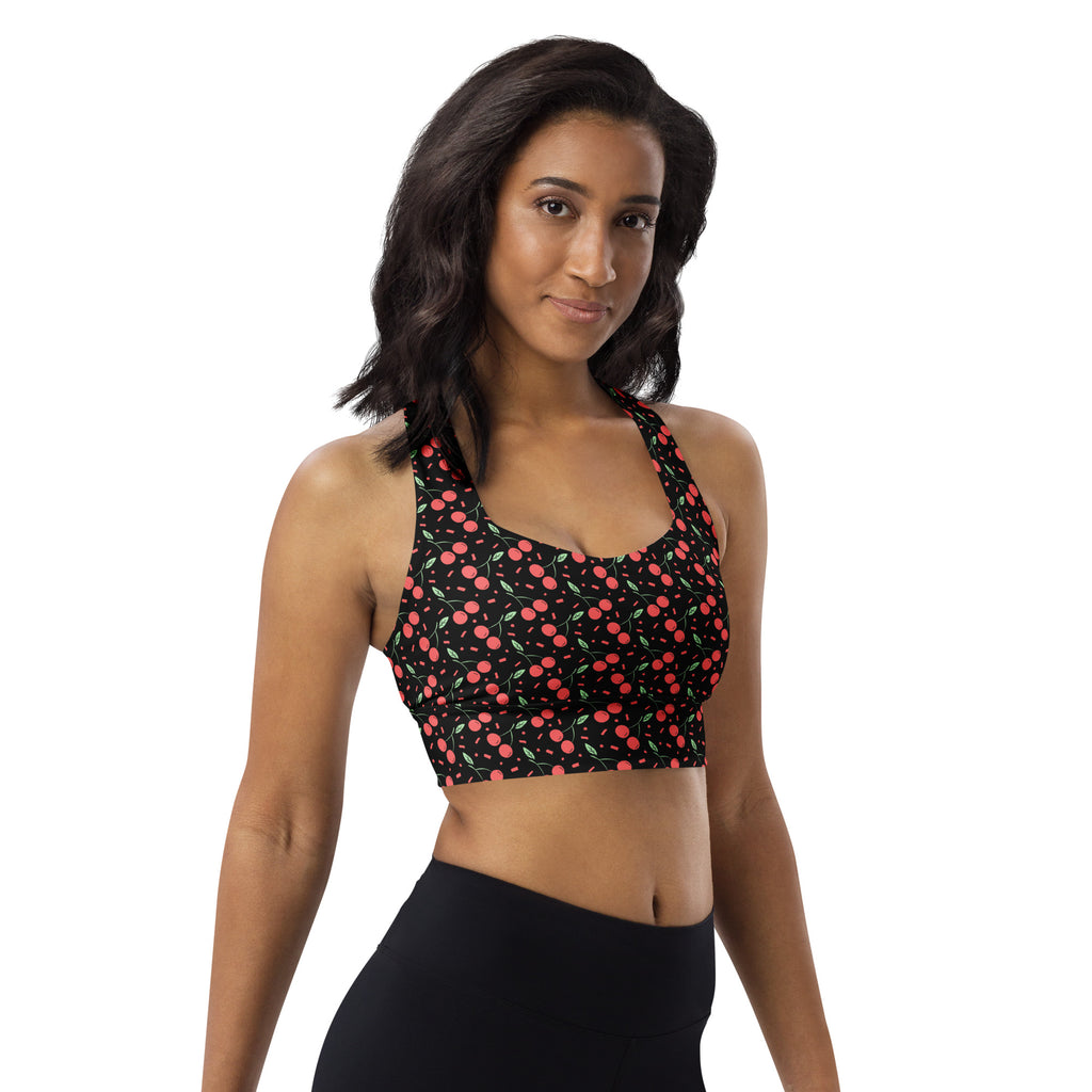 Women’s black buttery soft recycled longline sports bra with playful pink and green cherry pattern for high intensity support