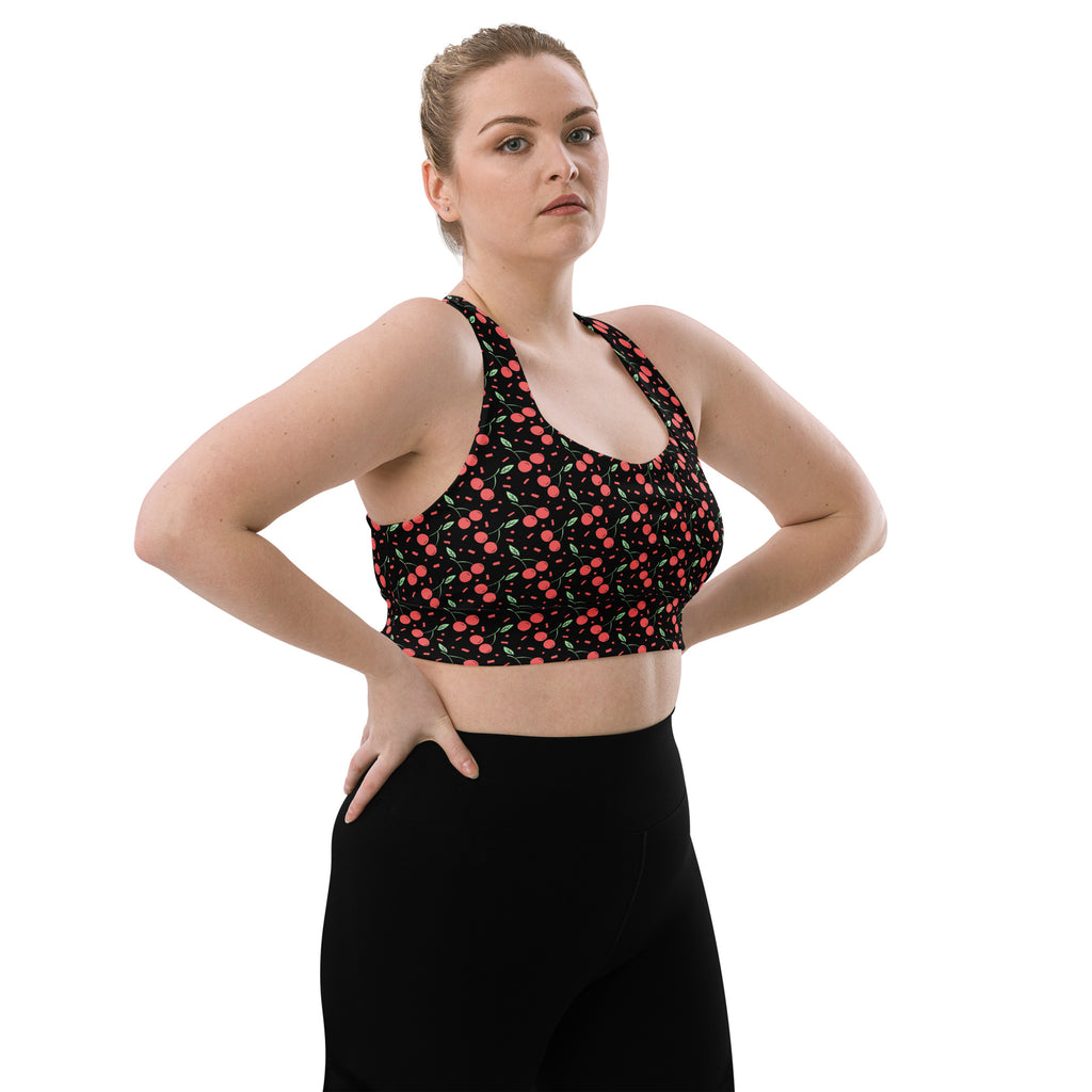 Black longline sports bra with playful pink and green cherry pattern buttery soft recycled fabric high intensity support