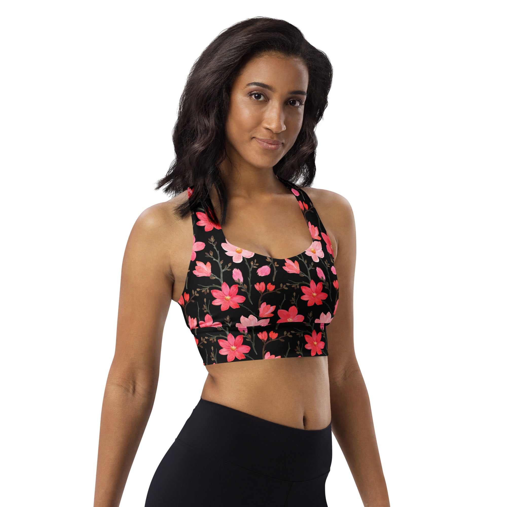 Women’s black longline sports bra with vibrant pink floral pattern buttery soft recycled fabric upf 50+