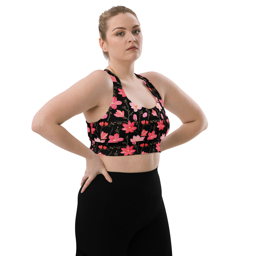 Women’s black sports bra with vibrant pink floral pattern buttery soft recycled fabric high intensity support