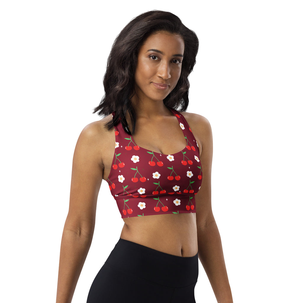 A maroon women’s longline sports bra with cherry and flower print offering high intensity support and quick dry fabric