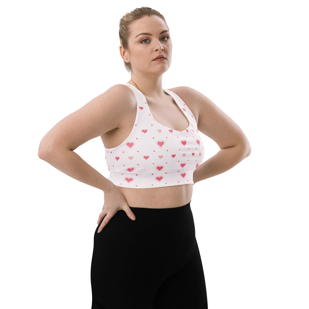 White buttery soft recycled longline sports bra with pink heart and dot pattern for high intensity support