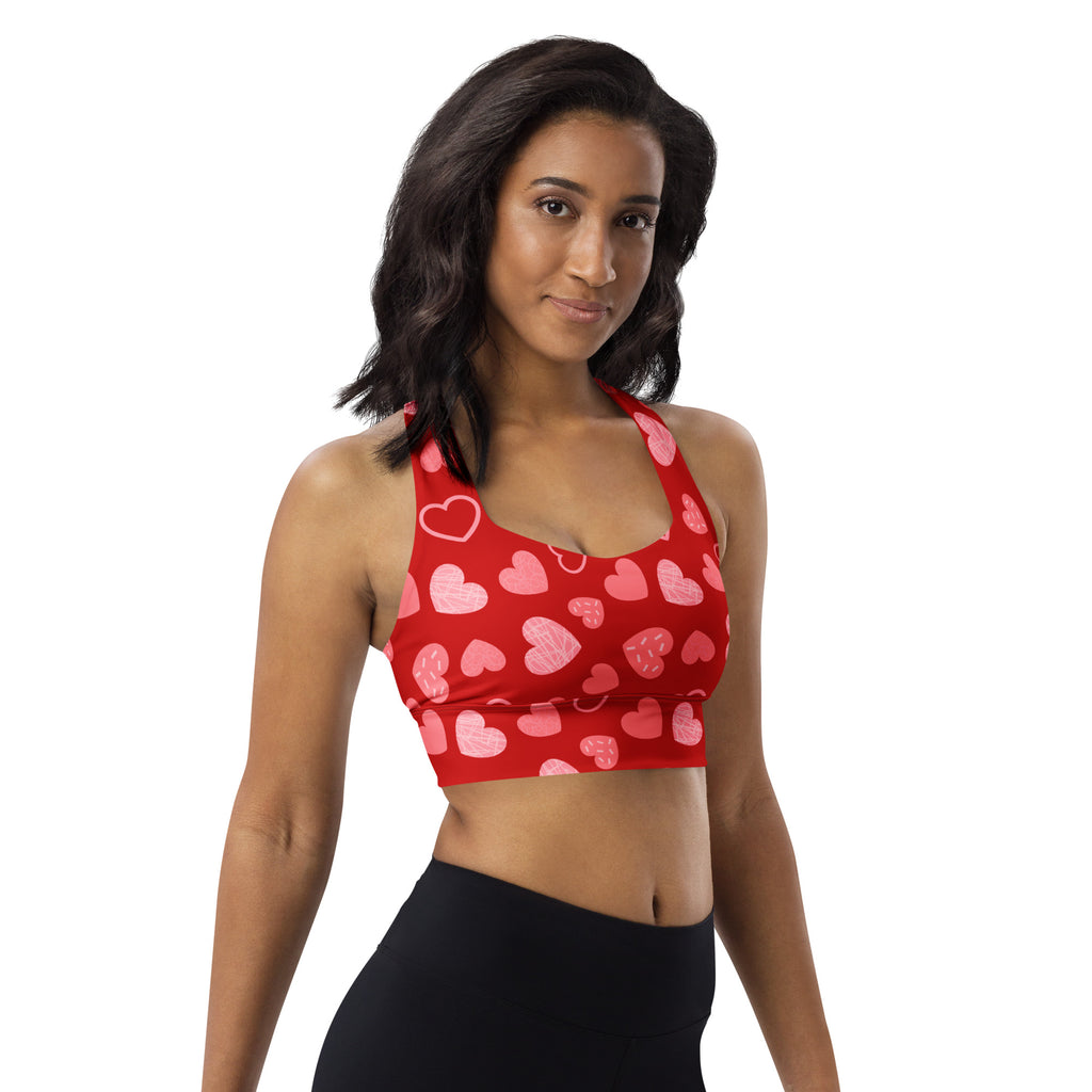 Women’s red buttery soft recycled longline sports bra with pink and white heart pattern for high intensity support