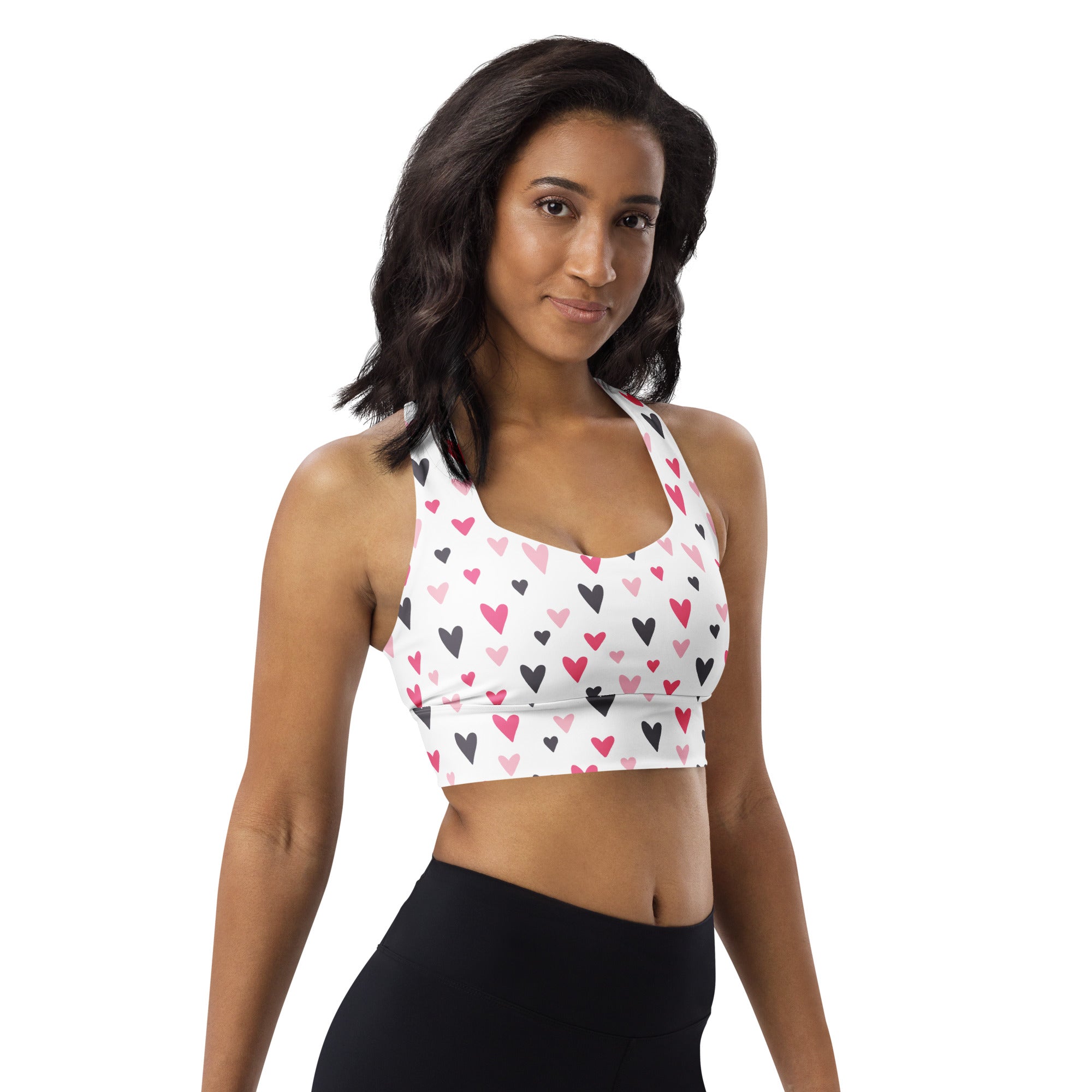 White longline sports bra with pink and black heart pattern high intensity support buttery soft recycled fabric