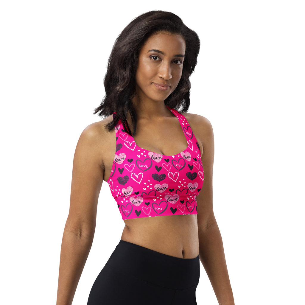 A vibrant pink longline sports bra with love heart pattern made from buttery soft recycled fabric for high intensity support