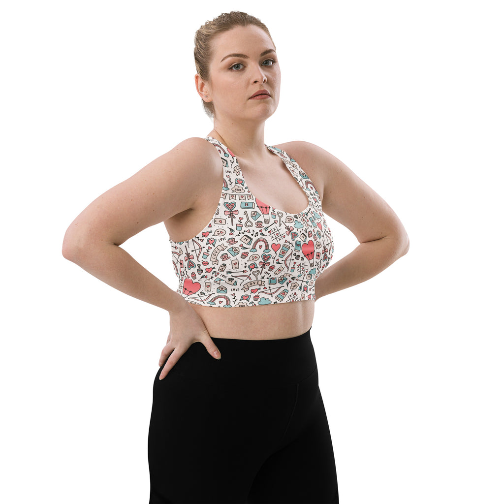 White longline sports bra with colorful doodle pattern hearts rainbows gift boxes buttery soft recycled fabric