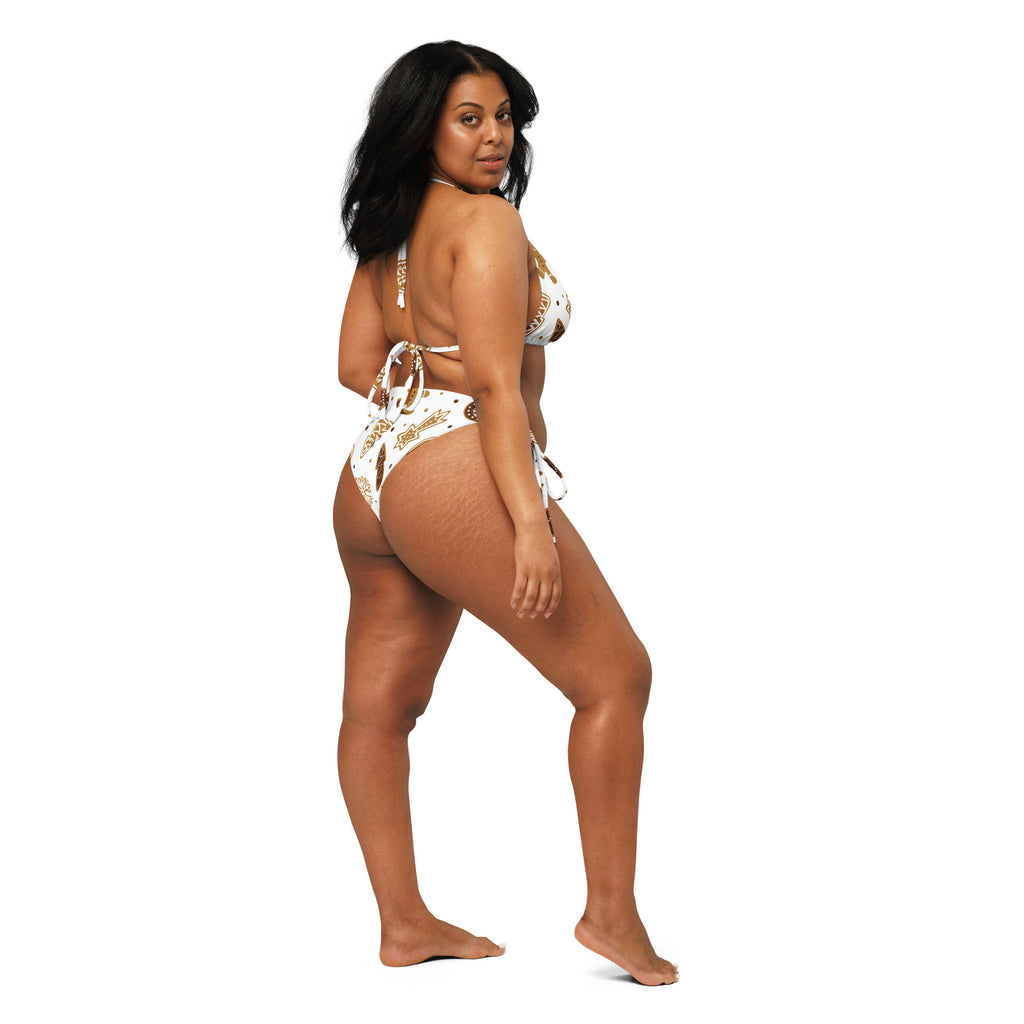 White and gold patterned two-piece recycled string bikini with tie-side straps and UPF 50 plus for sun protection