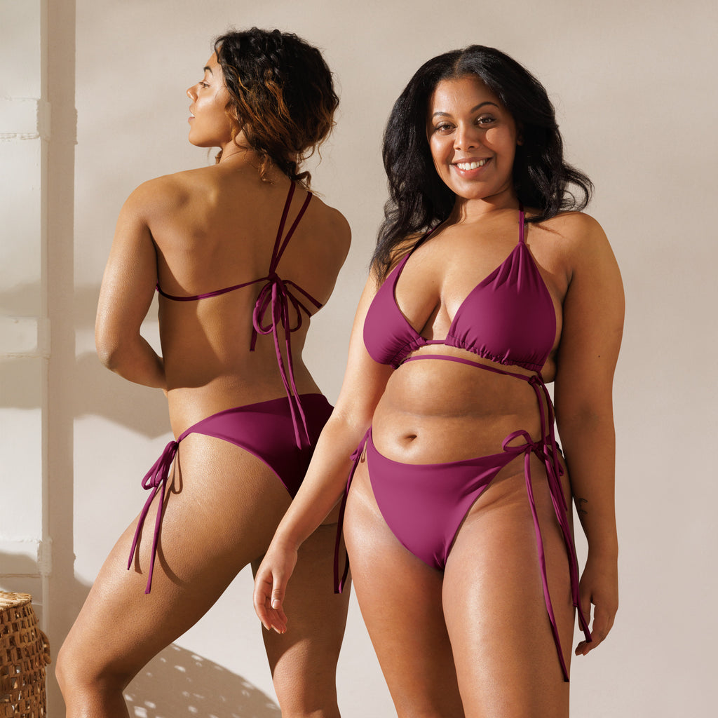 A vibrant magenta purple buttery soft recycled string bikini with triangle top, high-cut bottoms, and tie-side straps