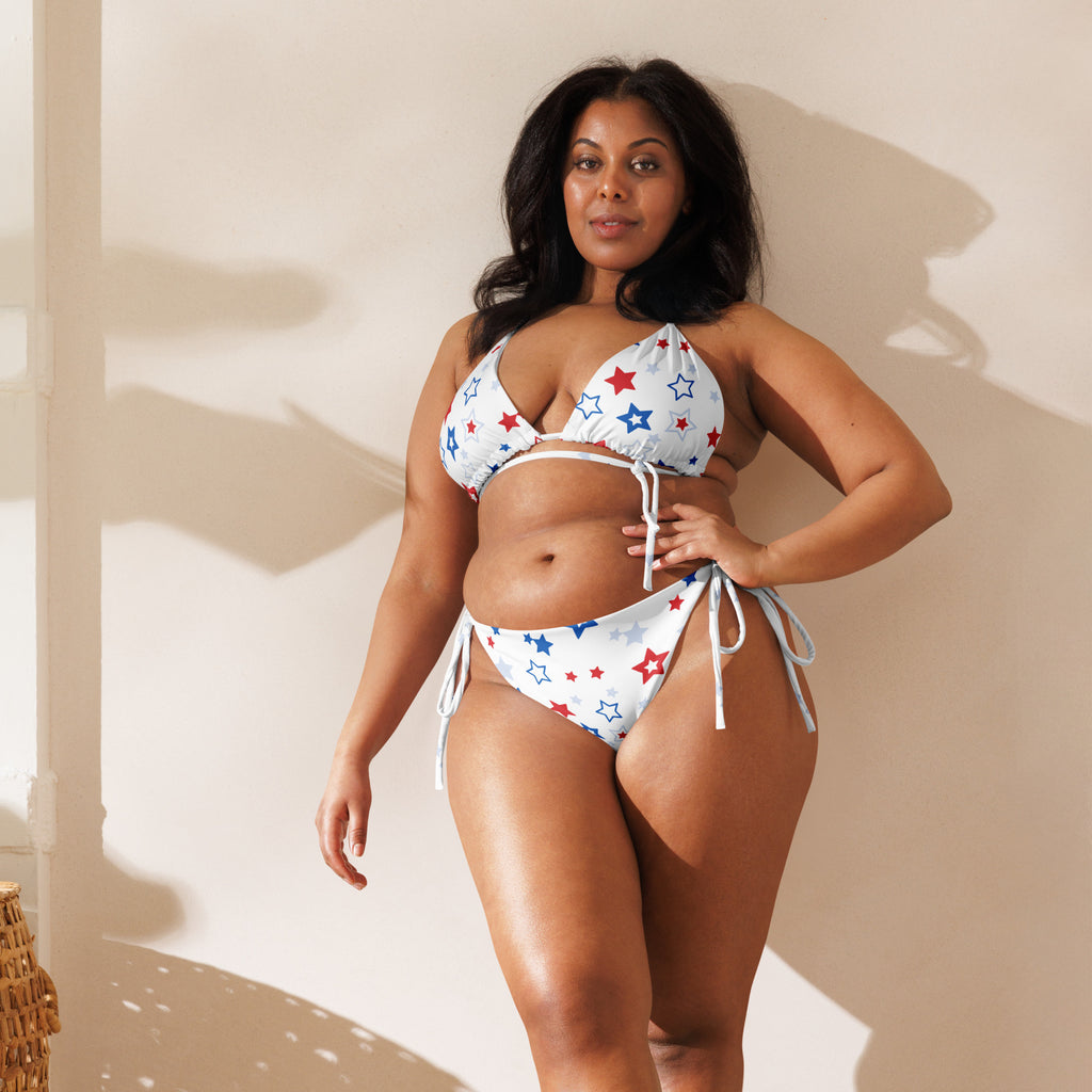 Women’s white recycled string bikini with red and blue star patterns and adjustable tie-side strings with upf 50+