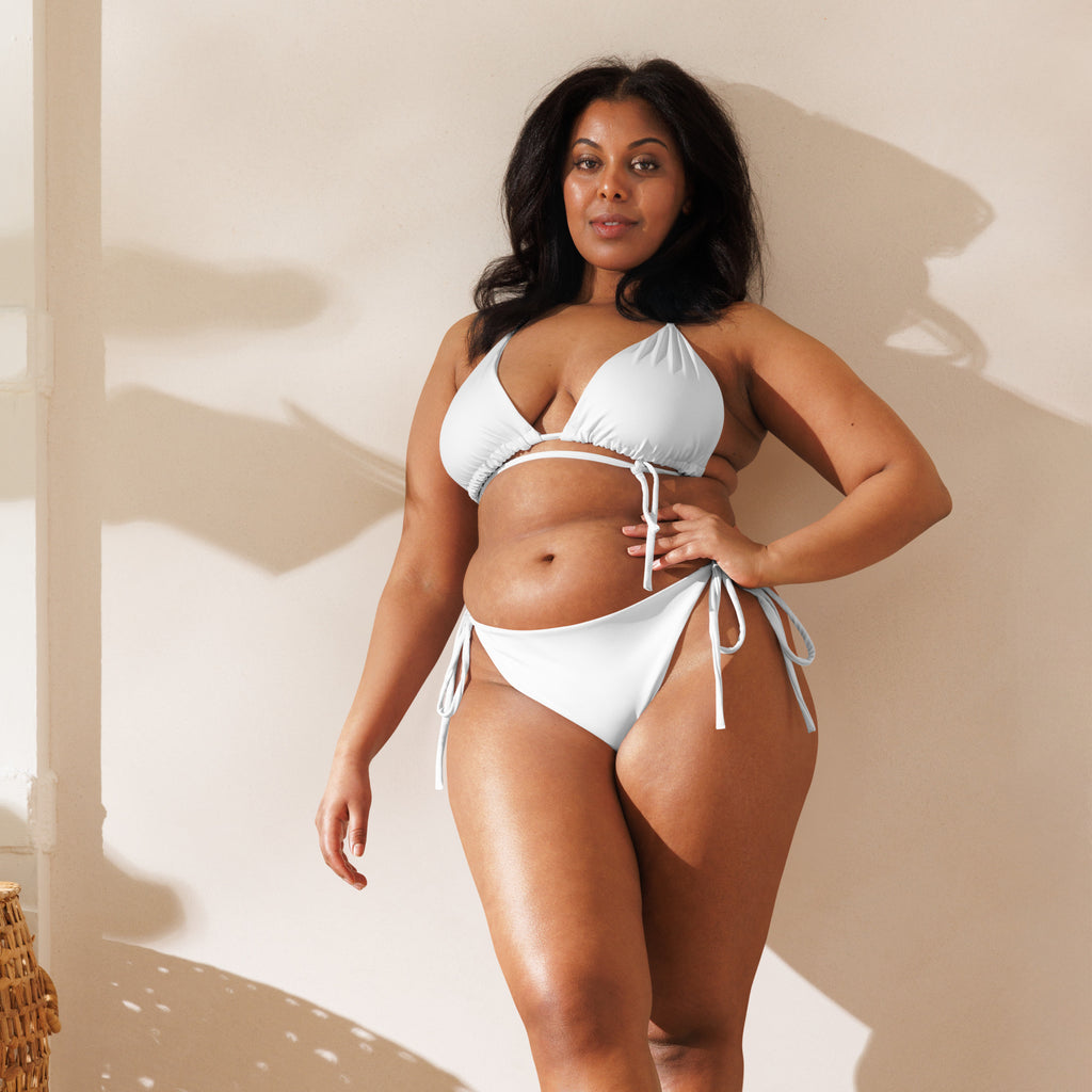 Women’s white buttery soft recycled string bikini with upf 50 plus featuring adjustable side ties and ruched triangle top