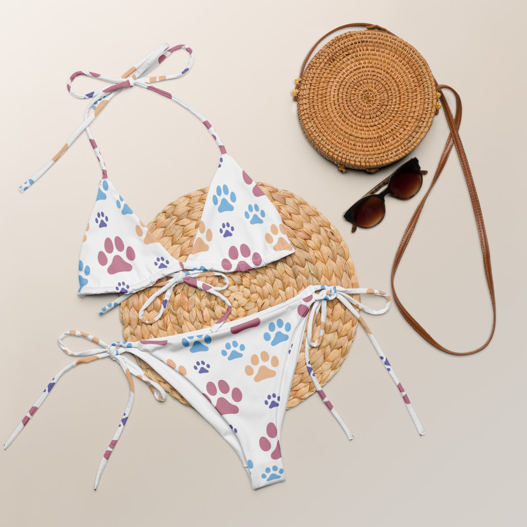 White bikini set with colorful blue pink and purple paw print patterns on buttery soft recycled fabric with upf 50+