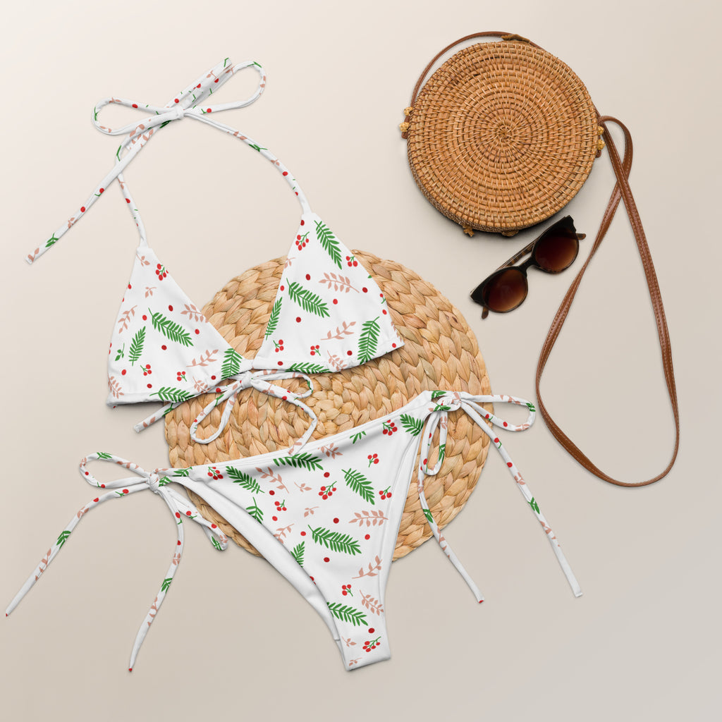 White buttery soft recycled string bikini set with green leaf and red berry print and adjustable tie-side strings