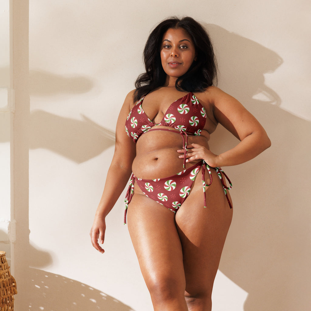 A womens red peppermint candy buttery soft recycled string bikini with upf 50 plus featuring adjustable ties and triangle top