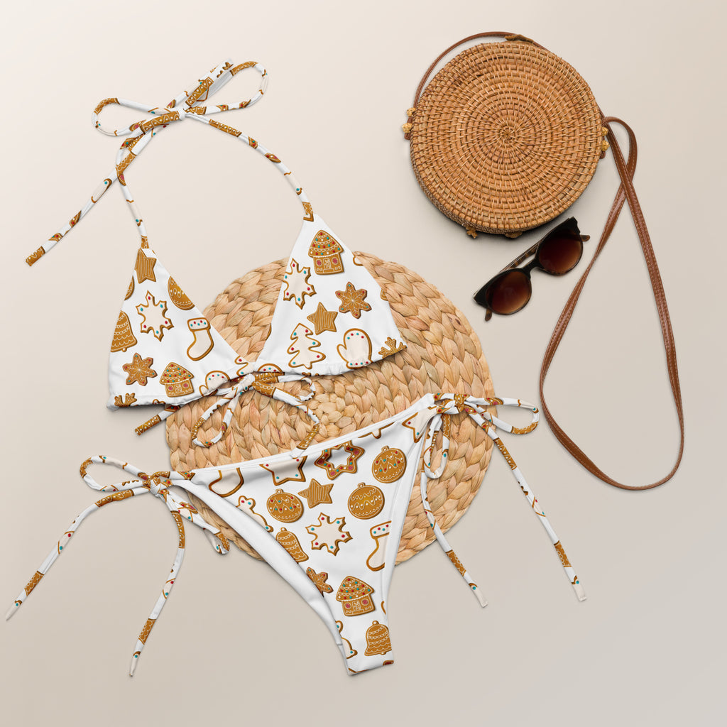 White bikini set with gold holiday-themed patterns and tie-side straps made from buttery soft recycled fabric with upf 50+
