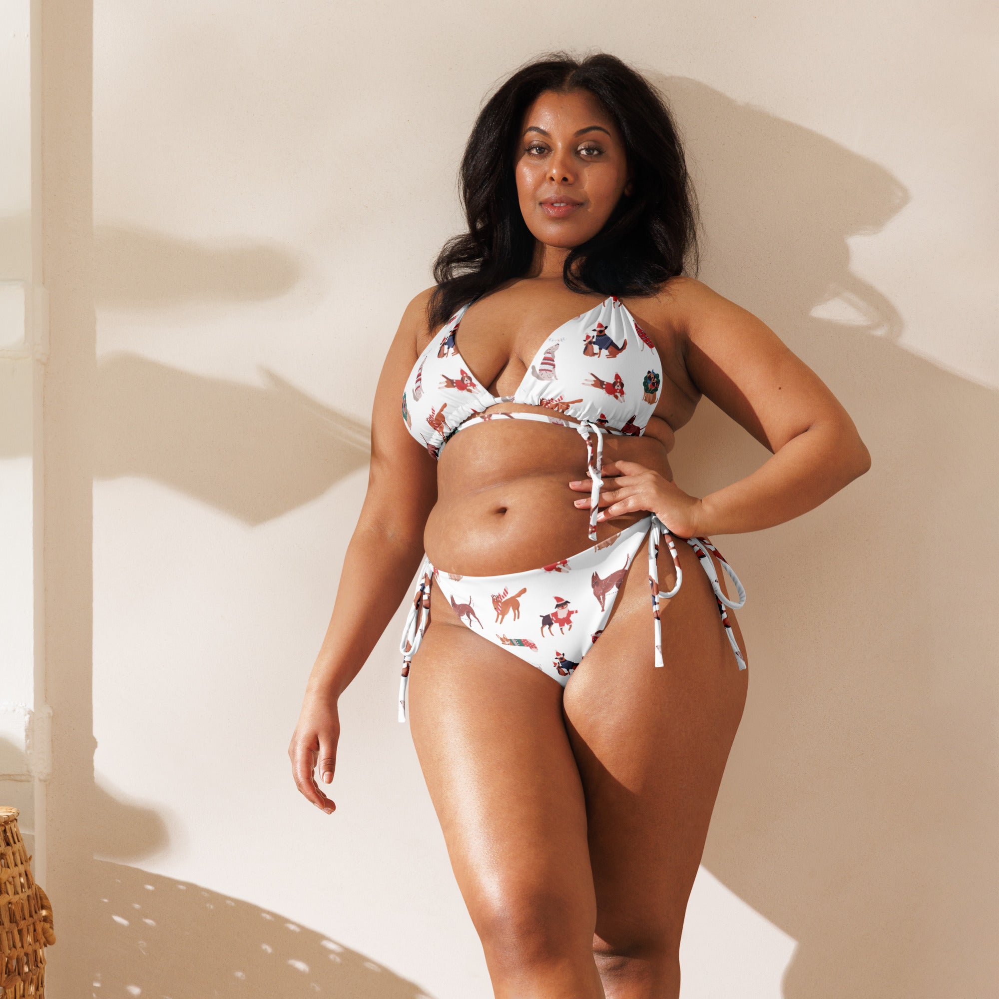 White buttery soft recycled string bikini with playful red and brown cartoon dogs and adjustable tie-side strings, upf 50+