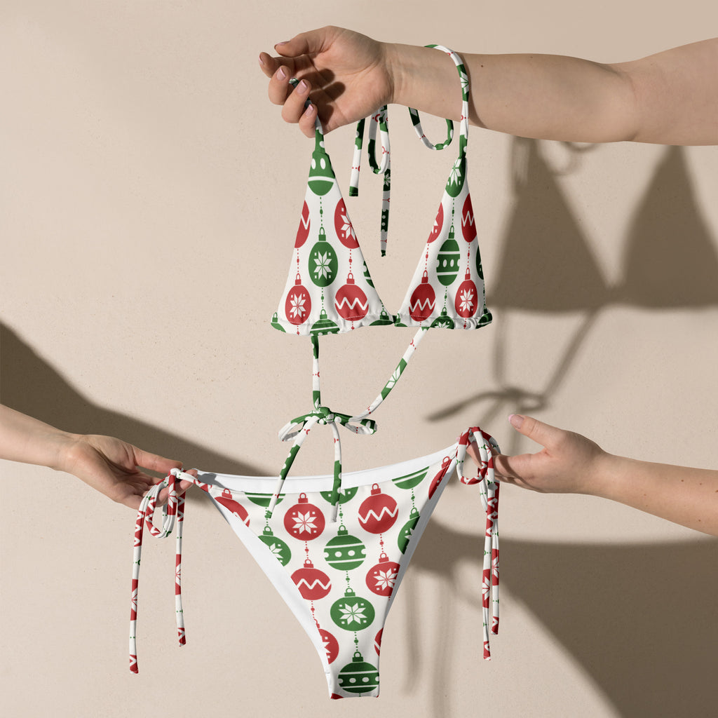 Women’s white recycled buttery soft string bikini with red and green christmas ornament patterns and upf 50 plus protection