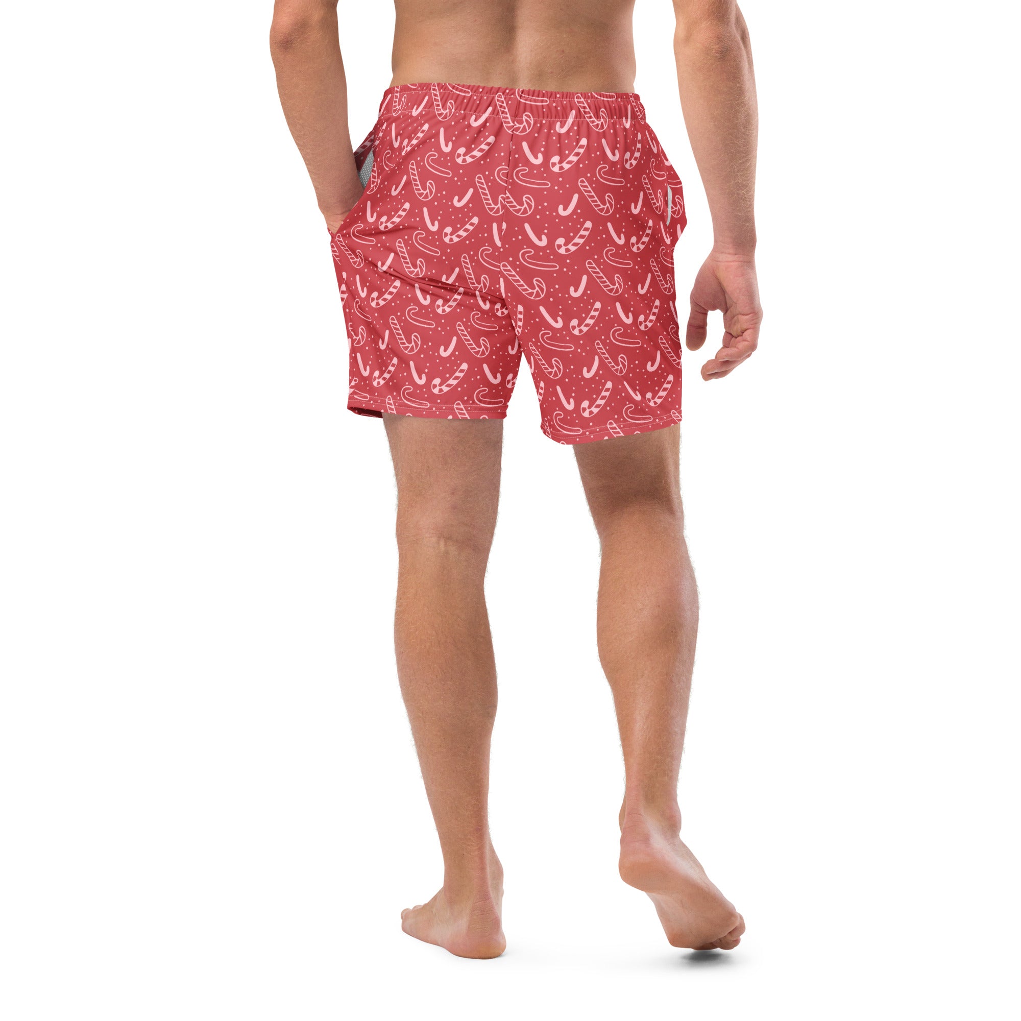 Men’s red swim trunks with a playful white candy cane pattern perfect for christmas beachwear