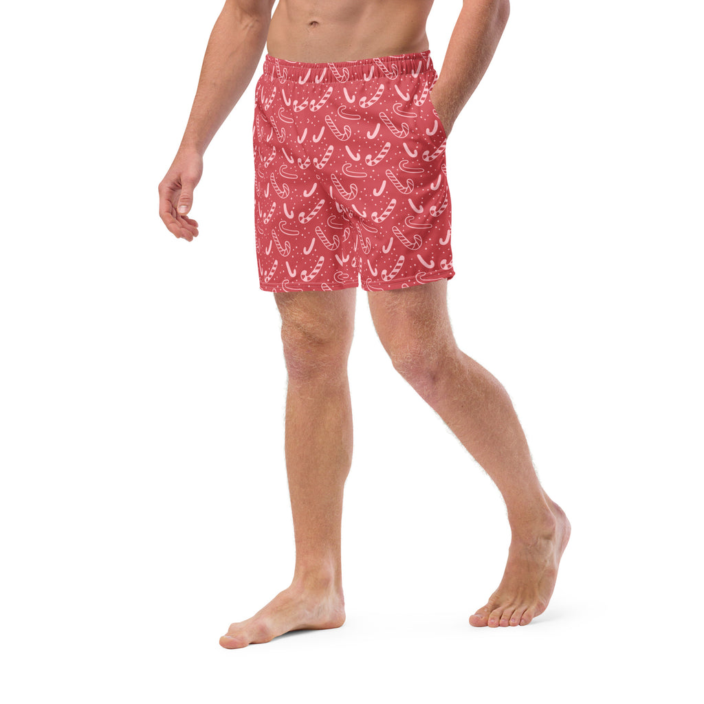 Men’s red candy cane christmas swim trunks featuring white candy cane pattern on lightweight fabric