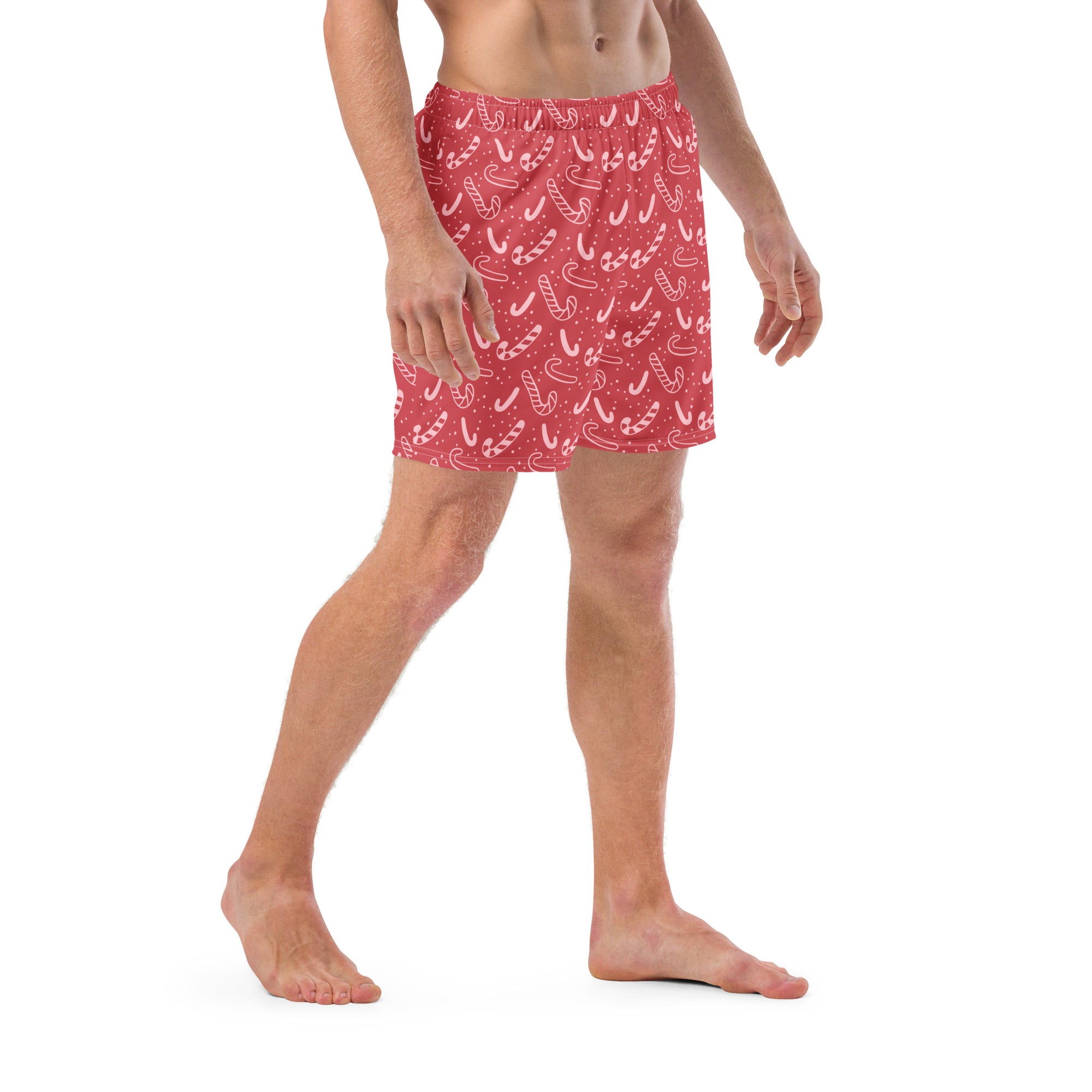 Men’s red candy cane christmas swim trunks with playful white candy cane and dot pattern perfect for festive beachwear