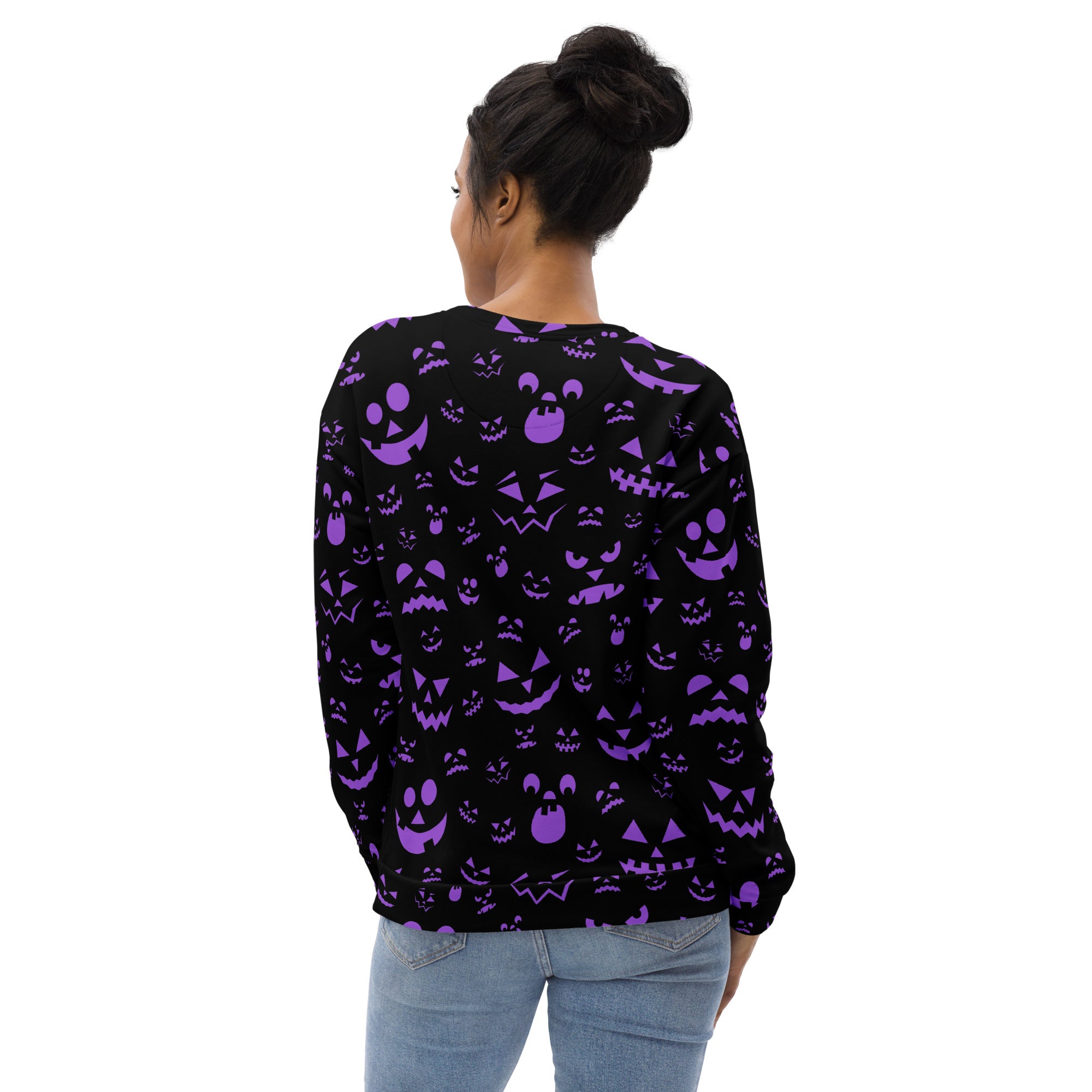Back of a black long-sleeved sweatshirt with vibrant purple jack-o-lantern pattern and brushed inner fleece fabric