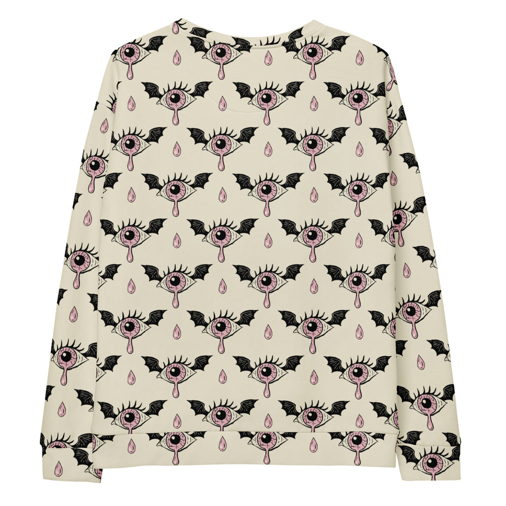 Cream-colored long-sleeved gothic eyeball halloween sweatshirt with pink and black eye wings and teardrop pattern and fleece lining