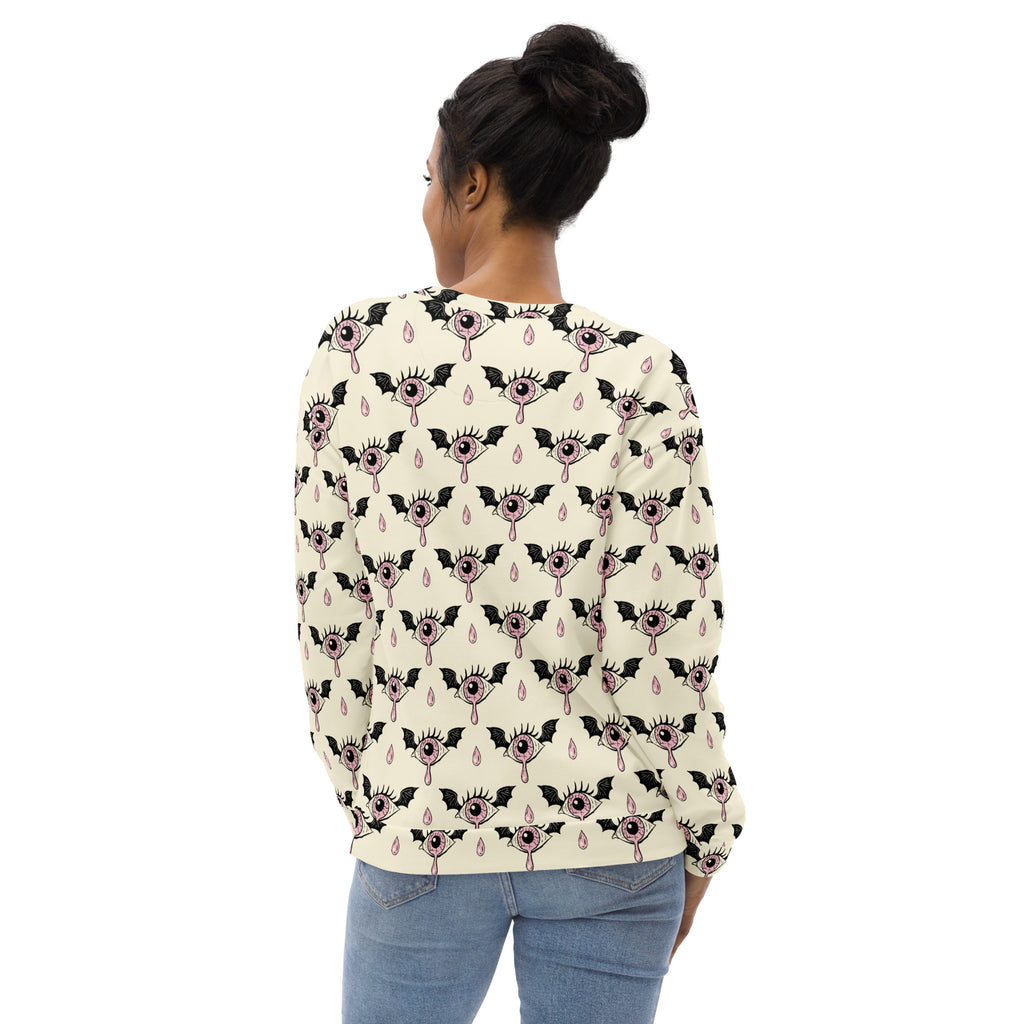 A cream-colored gothic eyeball Halloween sweatshirt with black bat pattern and brushed inner fleece fabric