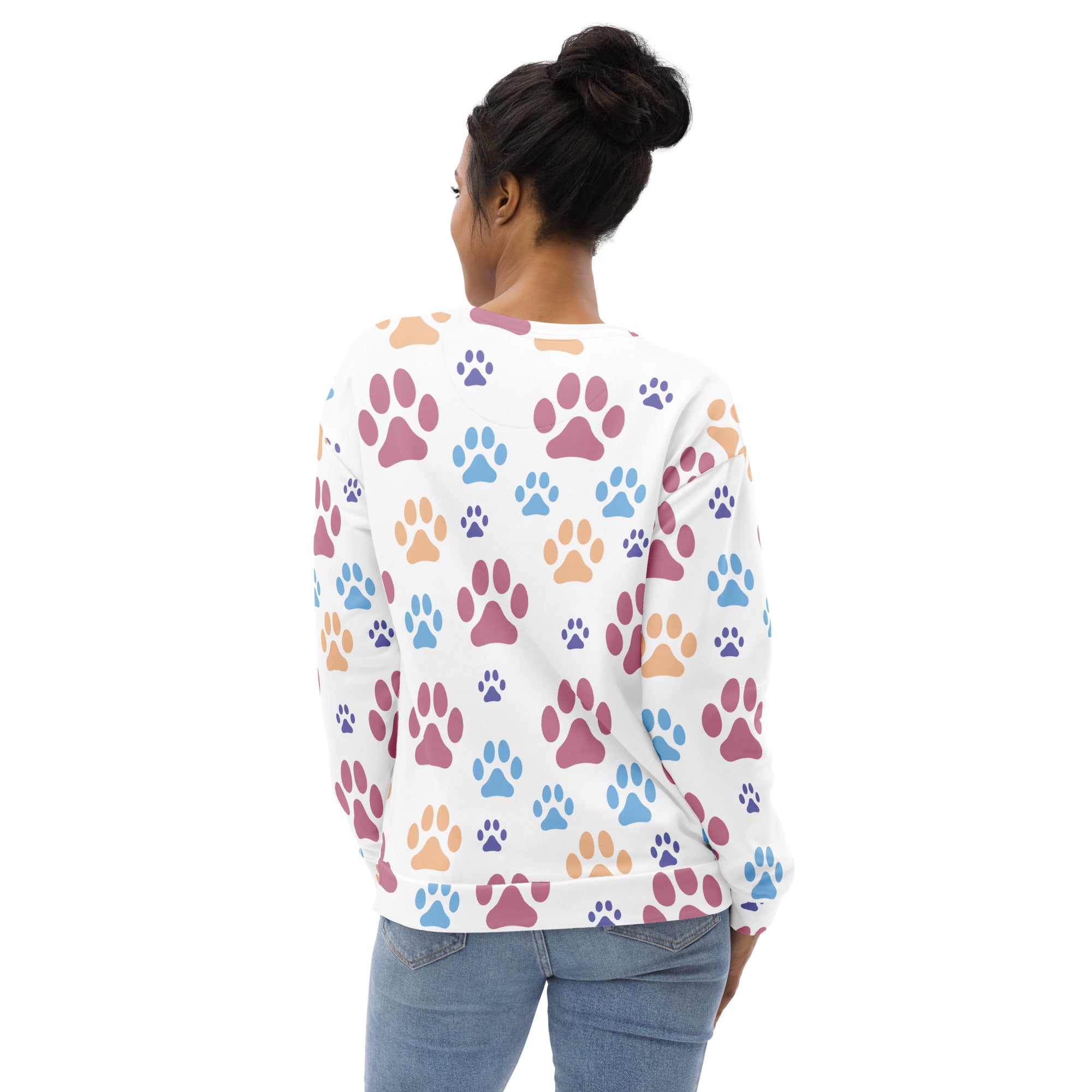 White long-sleeved sweatshirt with colorful pink blue and orange paw prints and brushed inner fleece fabric