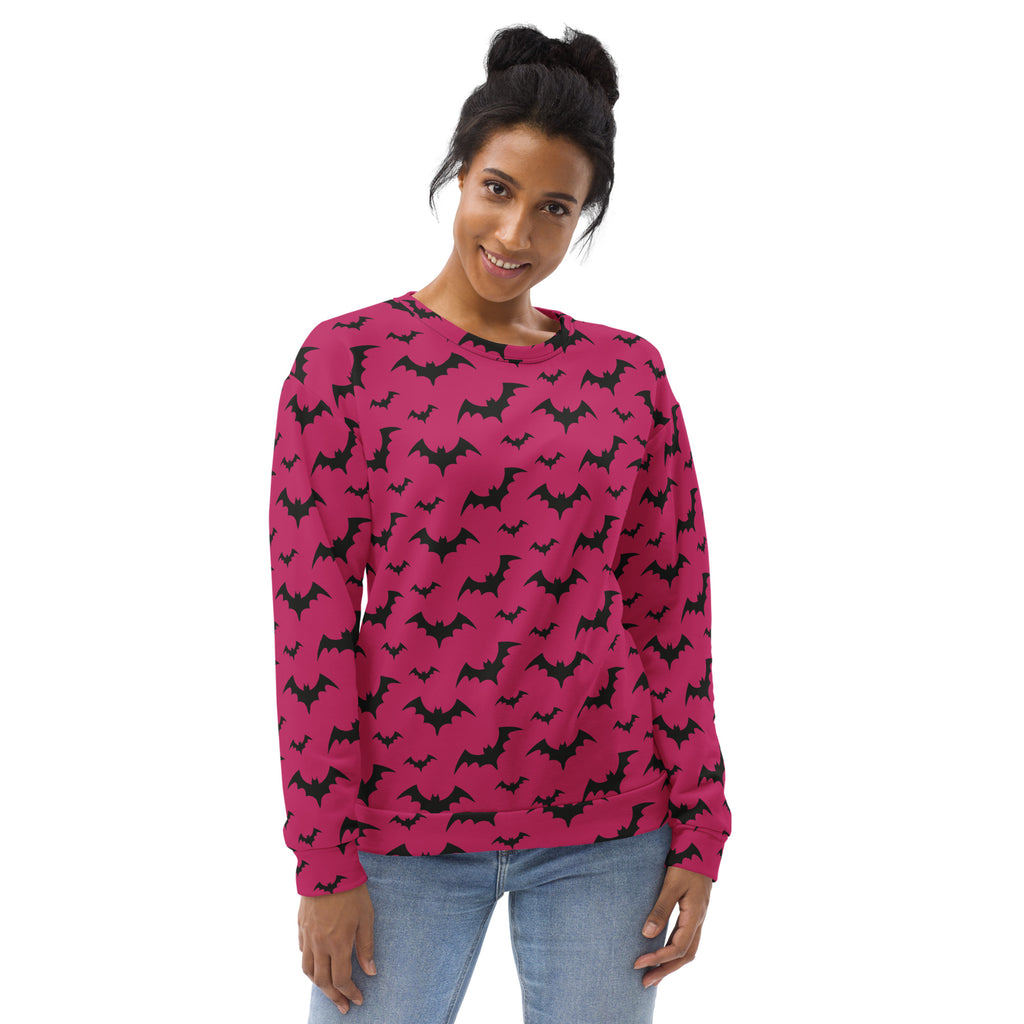 A vibrant pink long-sleeved sweatshirt with black bat pattern and brushed inner fleece fabric for Halloween wear
