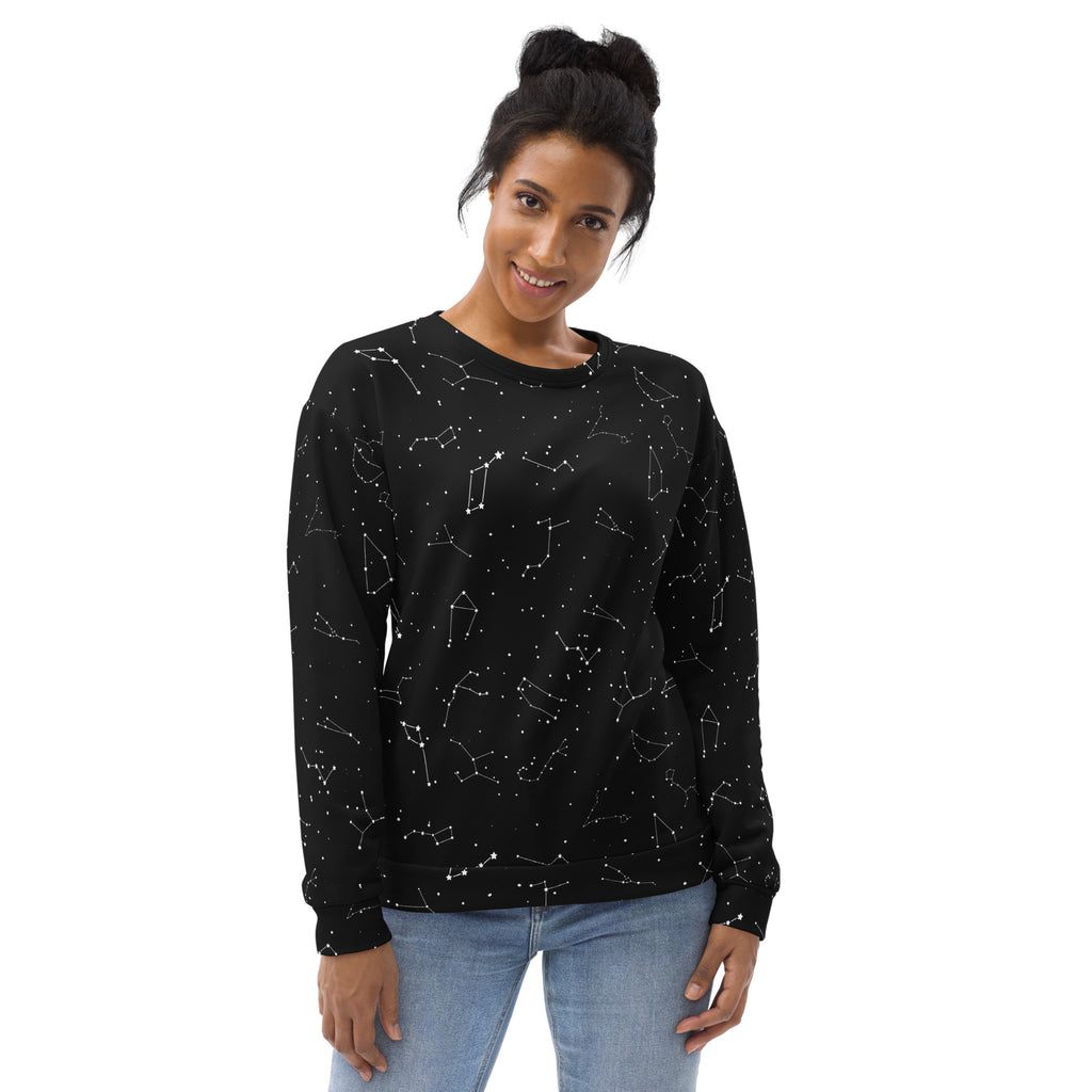 Woman wearing a black sweatshirt with white constellation pattern on a white background