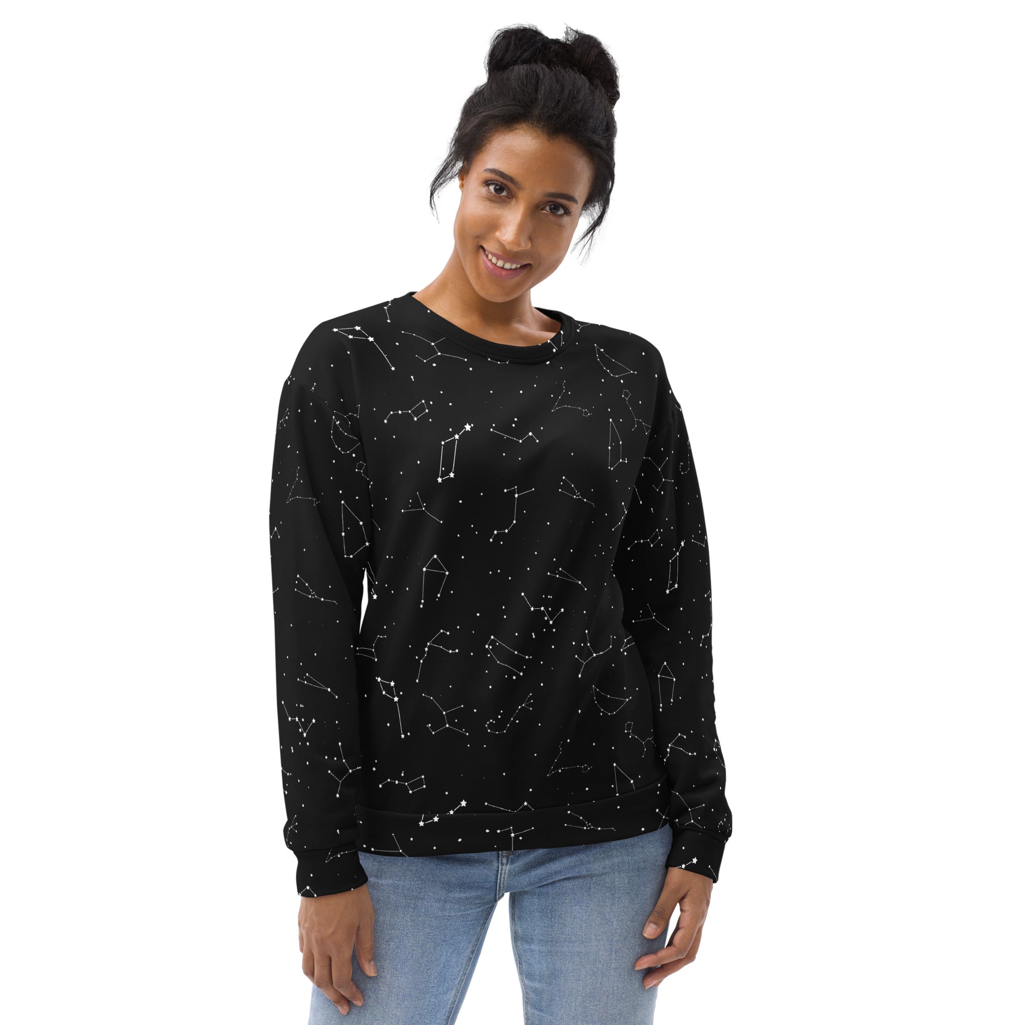 Woman wearing a black sweatshirt with white constellation pattern on a white background
