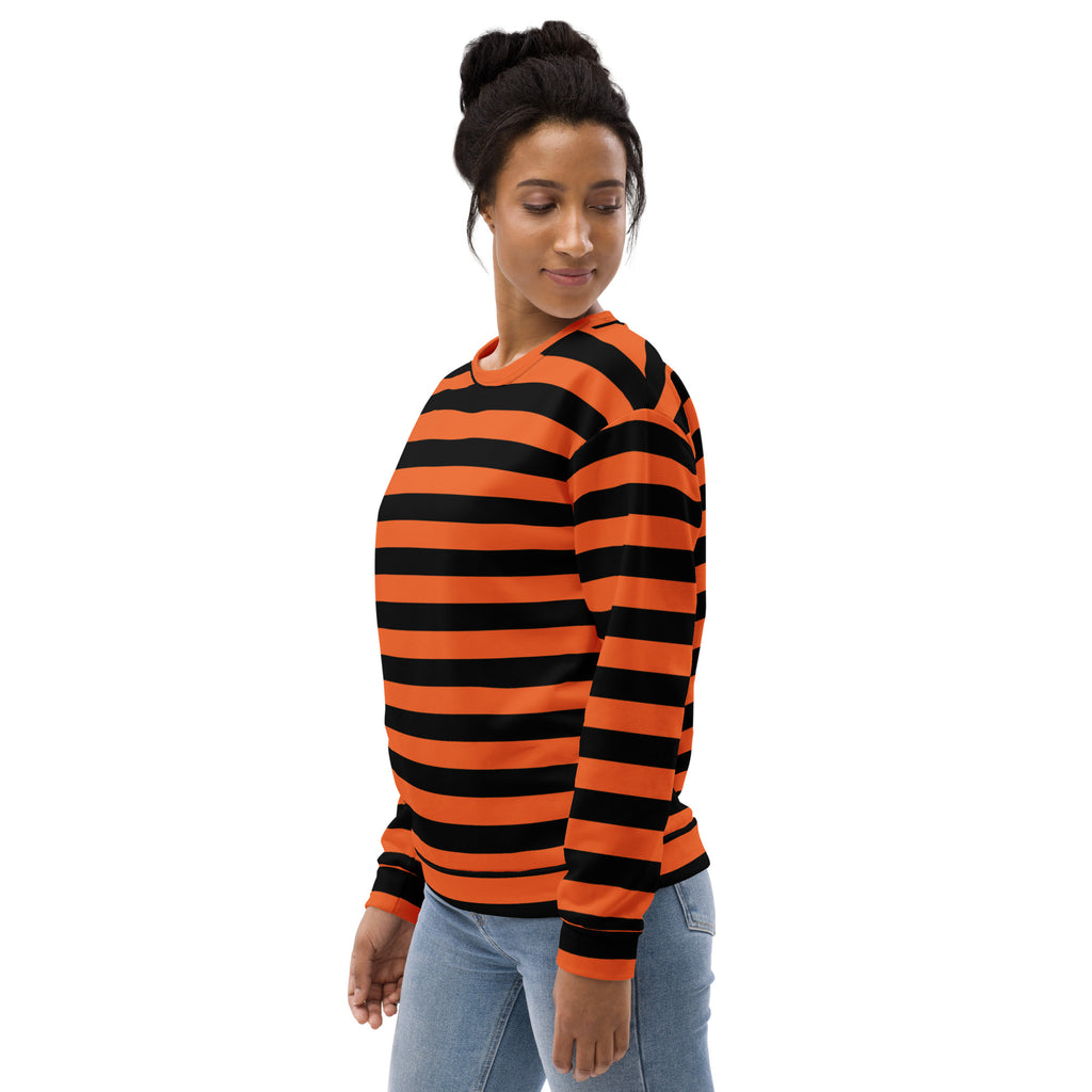 A woman wearing an orange and black striped halloween sweatshirt with brushed inner fleece fabric and long sleeves