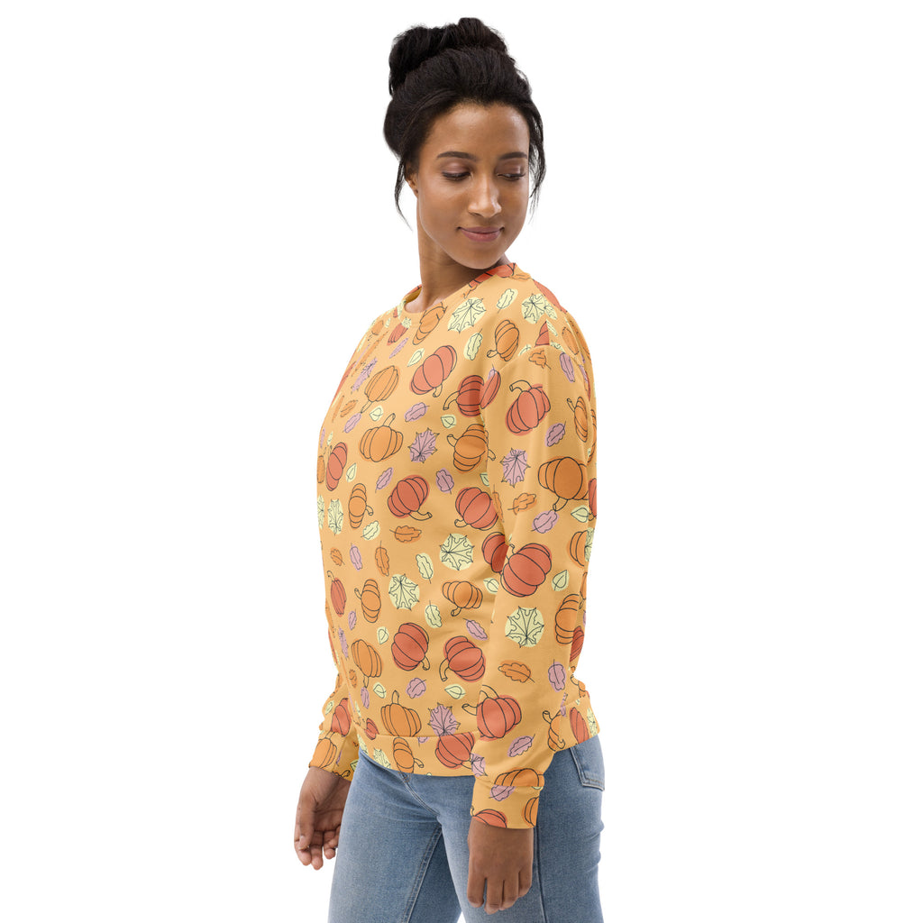 A soft orange long-sleeved sweatshirt with playful pumpkin and leaf patterns and brushed inner fleece fabric