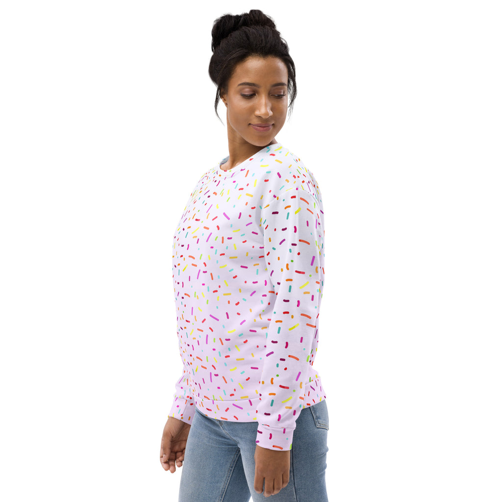 A soft pink long-sleeved sweatshirt with multicolored sprinkles and brushed inner fleece fabric for warmth
