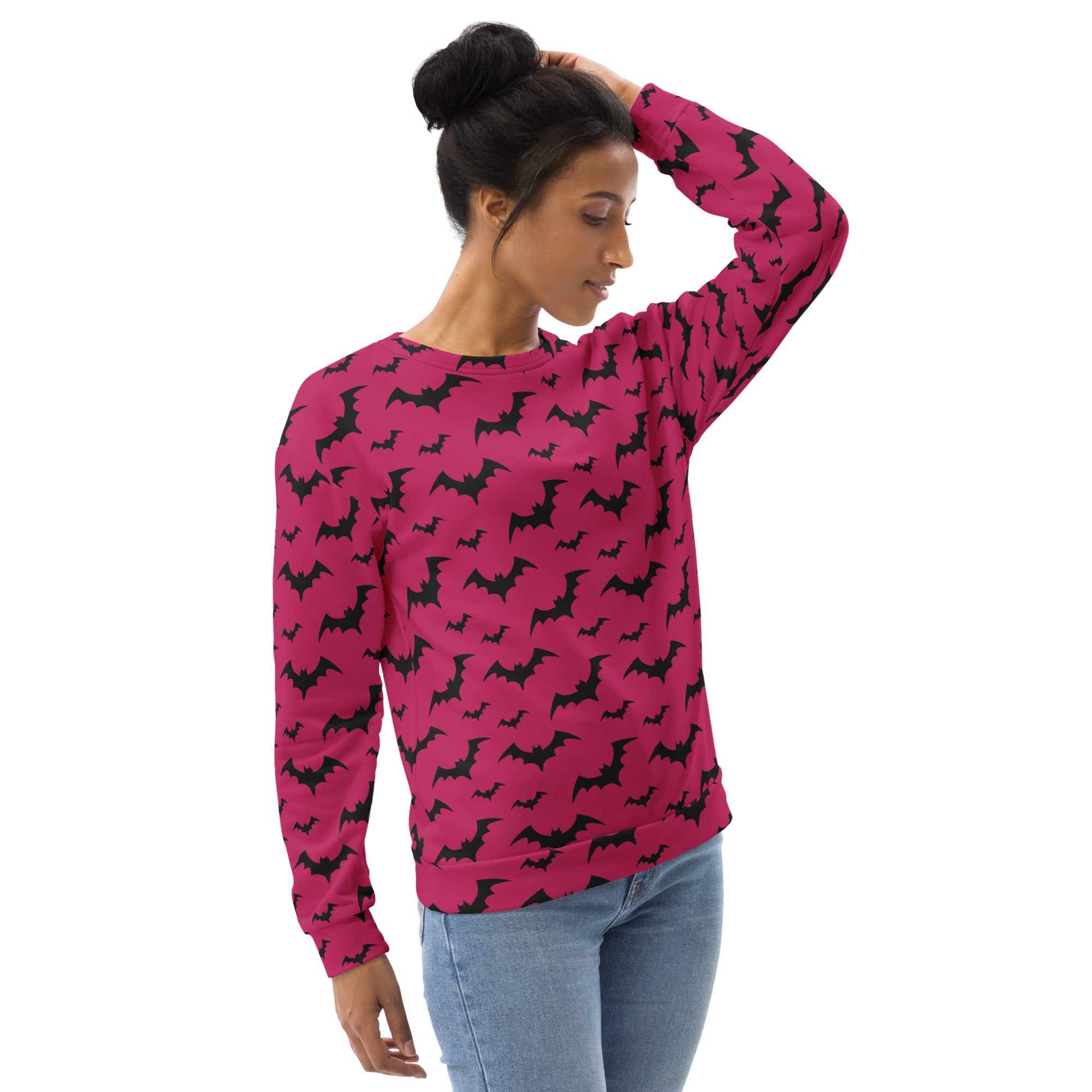 A vibrant pink long-sleeved sweatshirt with black bat pattern and brushed inner fleece fabric for Halloween