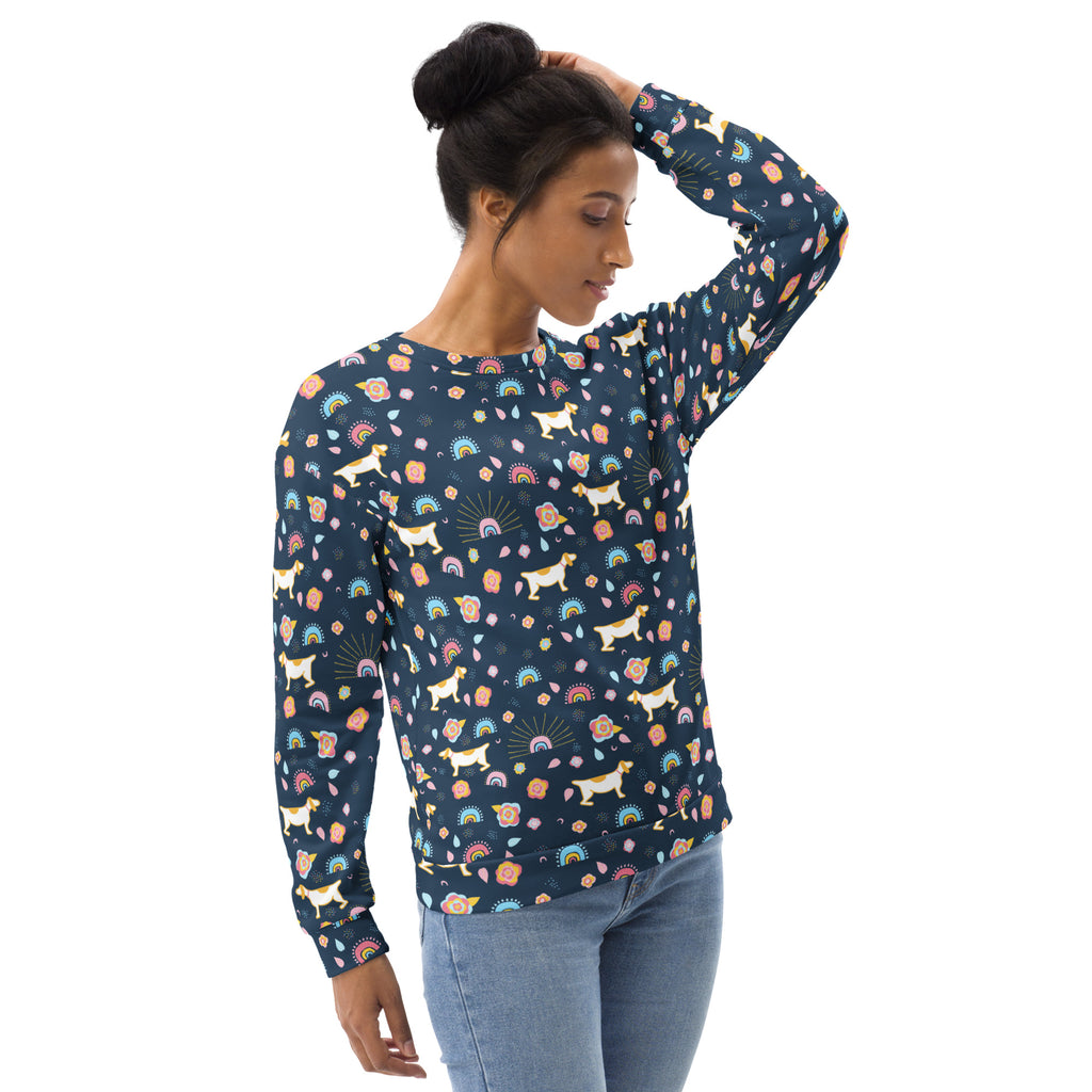 A navy blue long-sleeved sweatshirt with a playful white dog rainbow and pastel flower pattern and brushed fleece lining