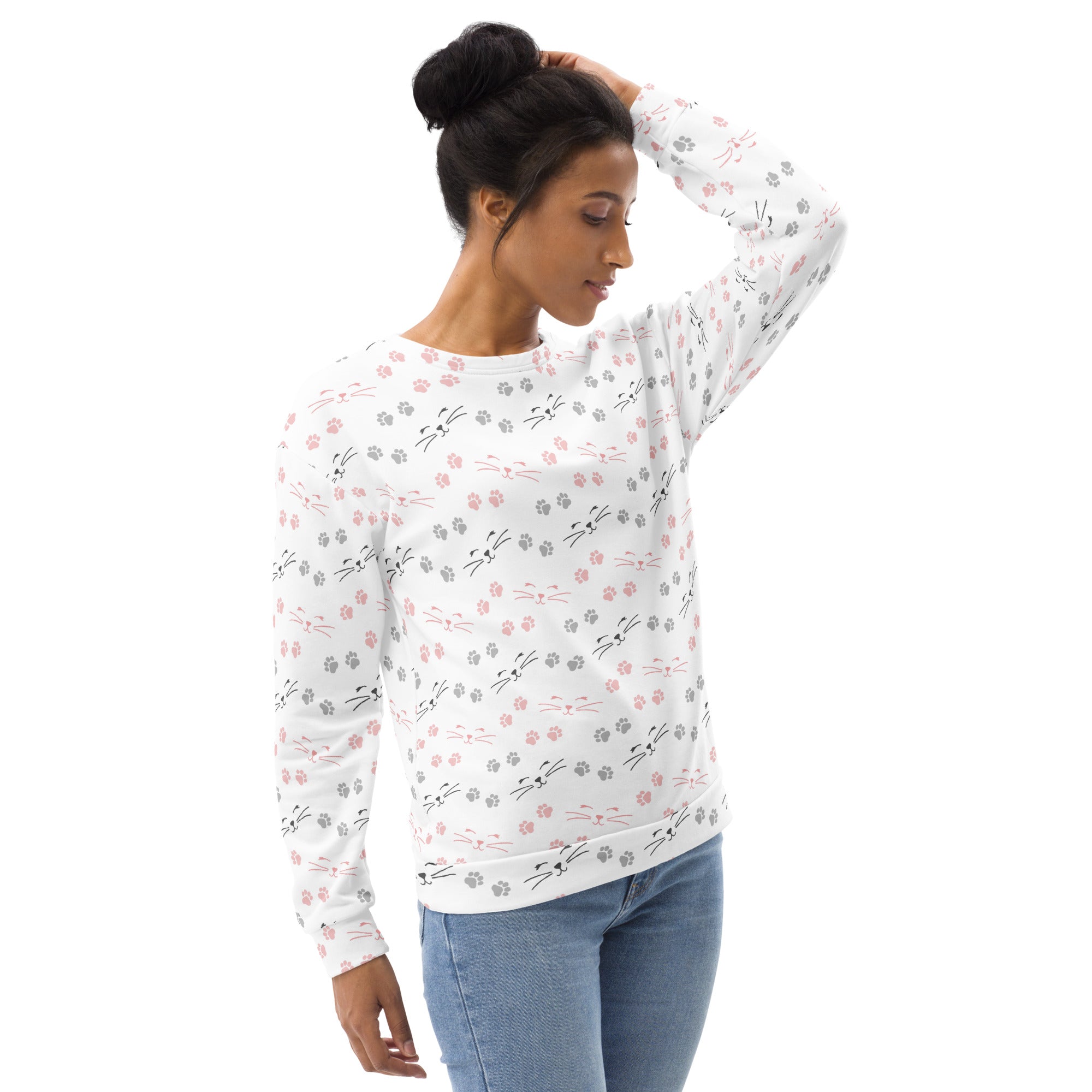 White long-sleeved sweatshirt with playful pink gray and black cat faces and paw prints made of brushed inner fleece fabric