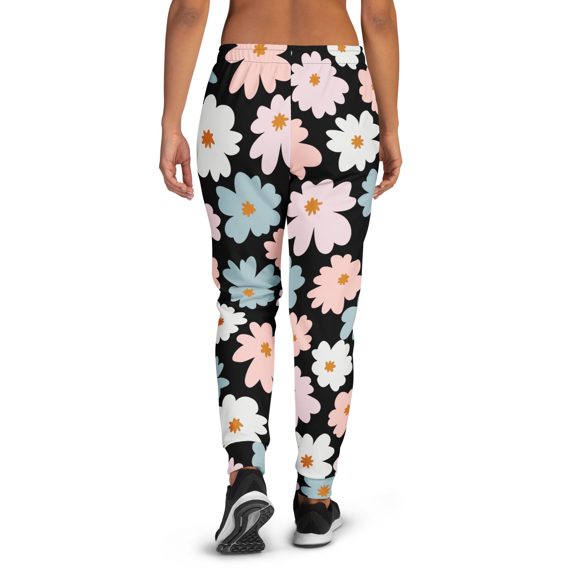 Women’s black recycled jogger pants with cozy brushed fleece inside and vibrant pink white blue daisies pattern