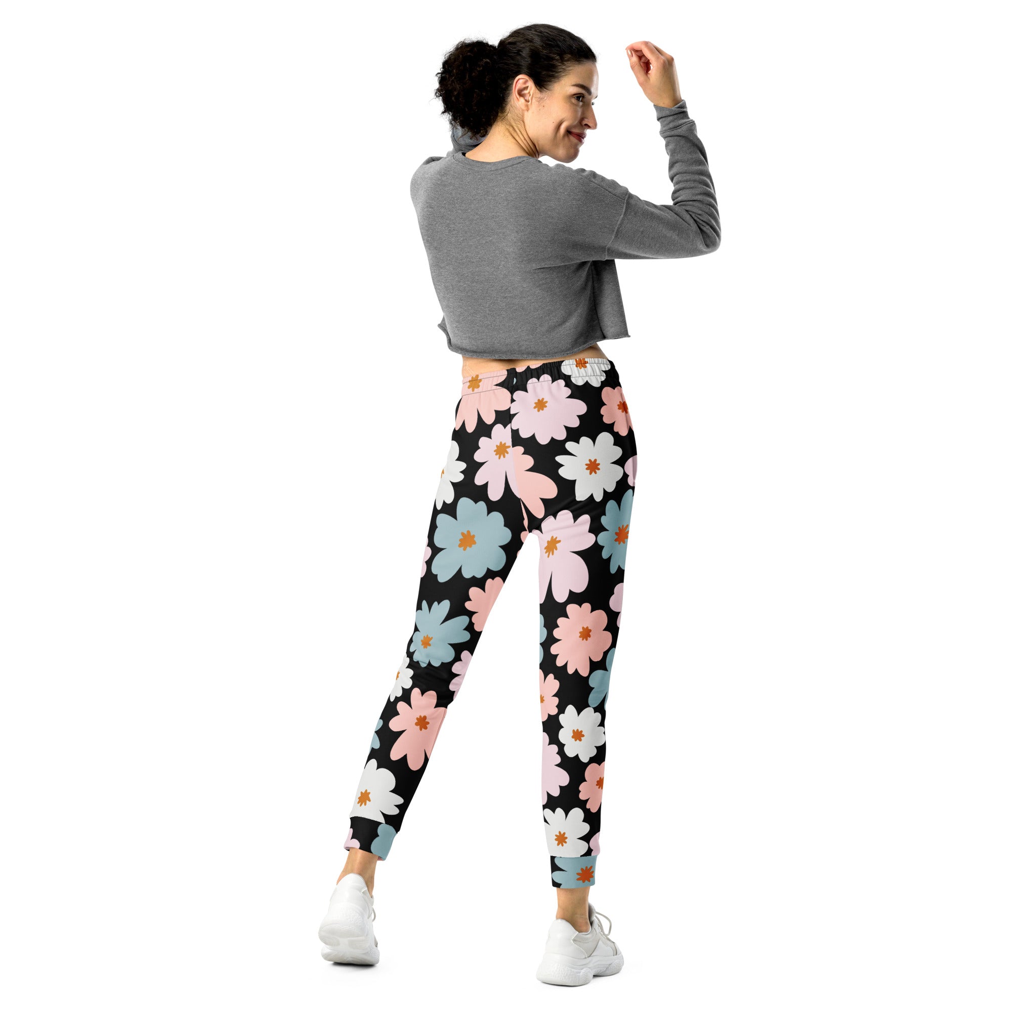 Women’s retro floral recycled jogger pants with pockets feature black leggings with pastel pink blue and white daisy pattern