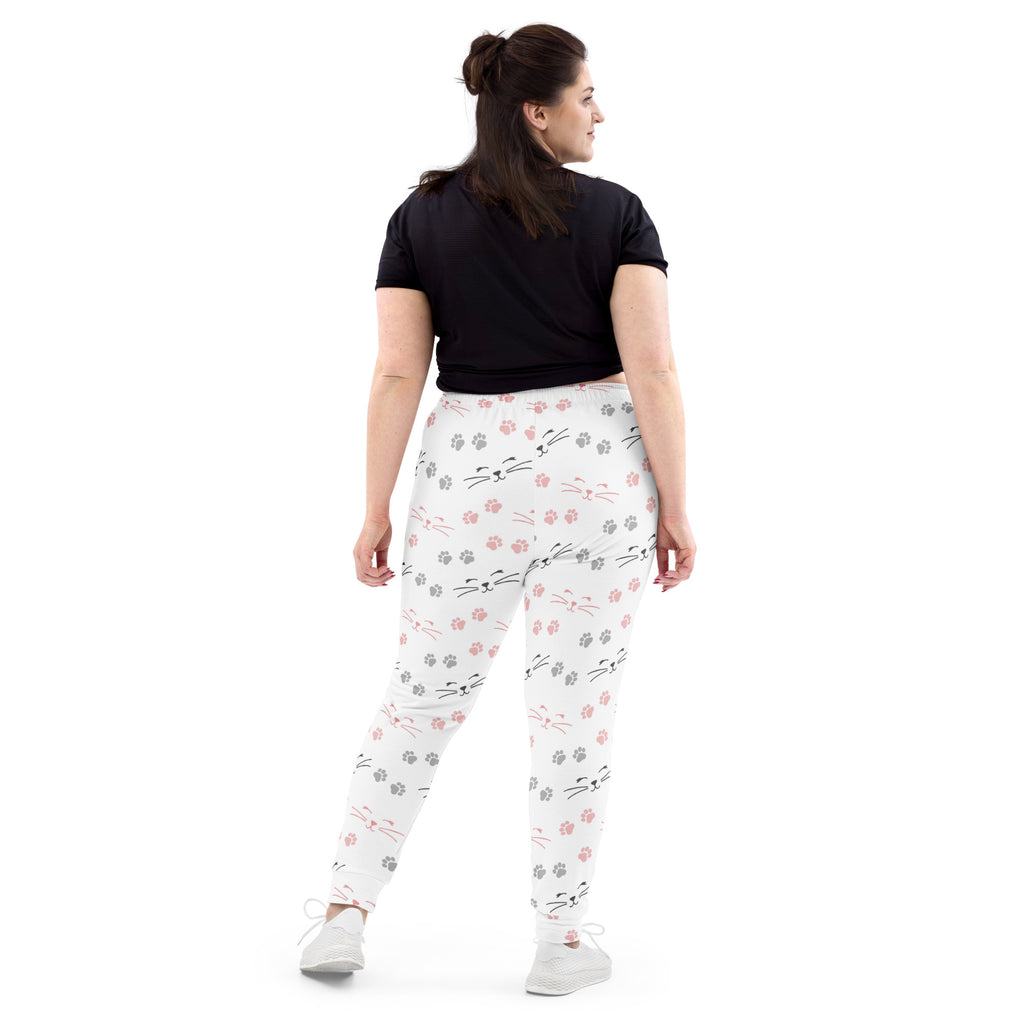 White leggings with pink and gray cat faces whiskers and paw prints made from cozy brushed recycled fleece with pockets