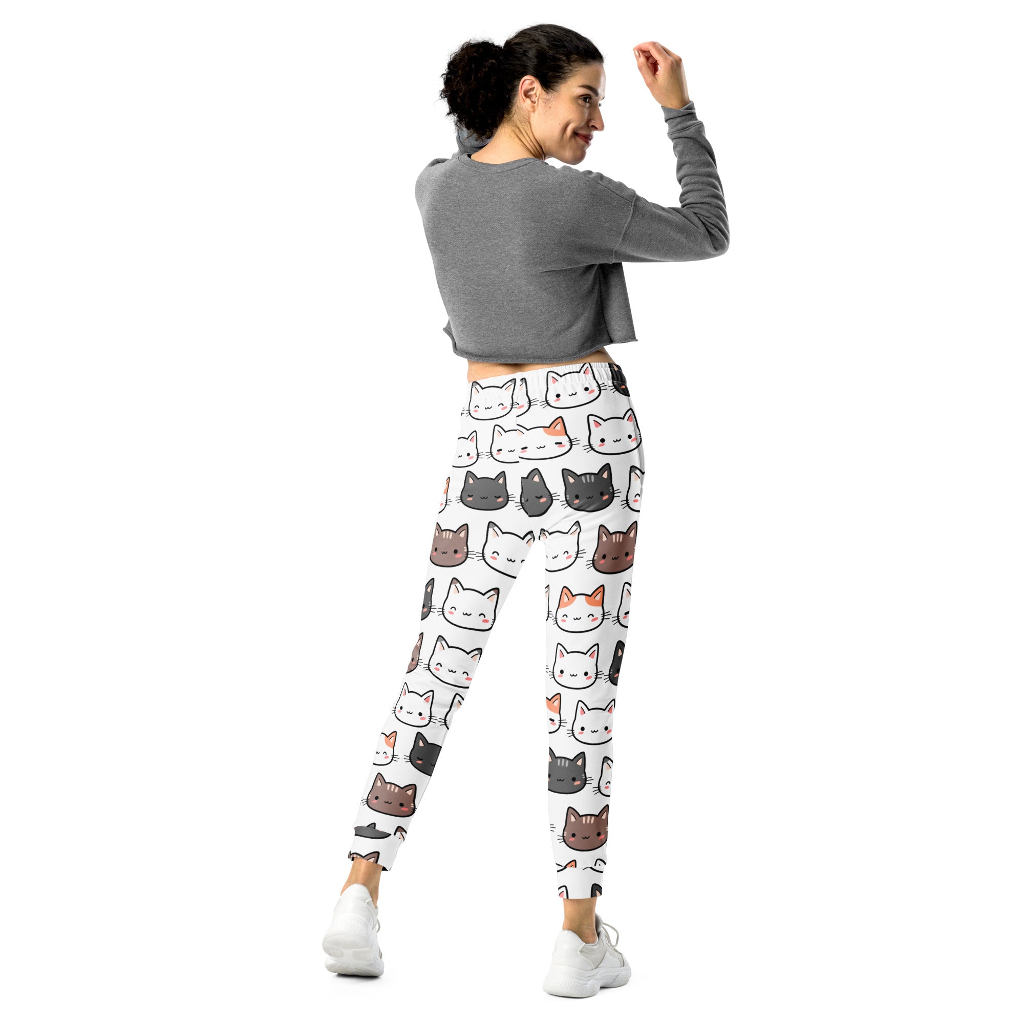 Women’s white recycled jogger pants with cozy fleece inside featuring colorful cartoon cat patterns and pockets